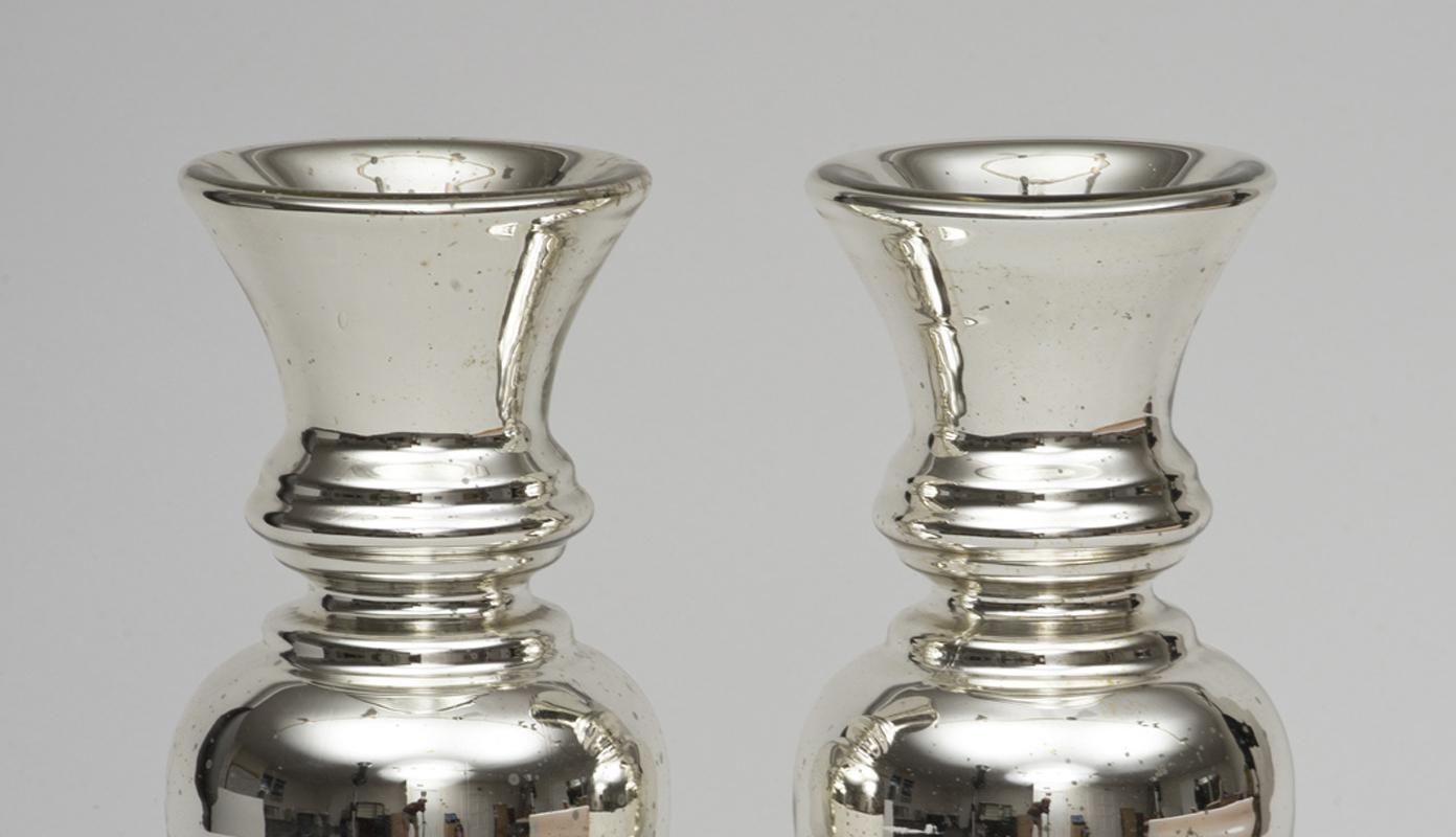 Pair of baluster shaped mercury glass vases with ring turnings around the neck.
