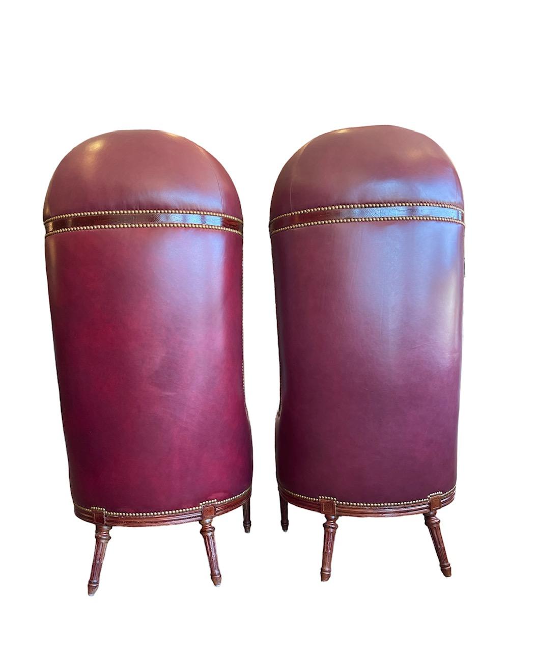 A lustrous crushed red velvet paints the concave back of this rare beauty. The sheer height of these chairs gives them a throne-like feeling. The outside back is covered in a satiny rouge Italian velvet that is decorated with gold French natural
