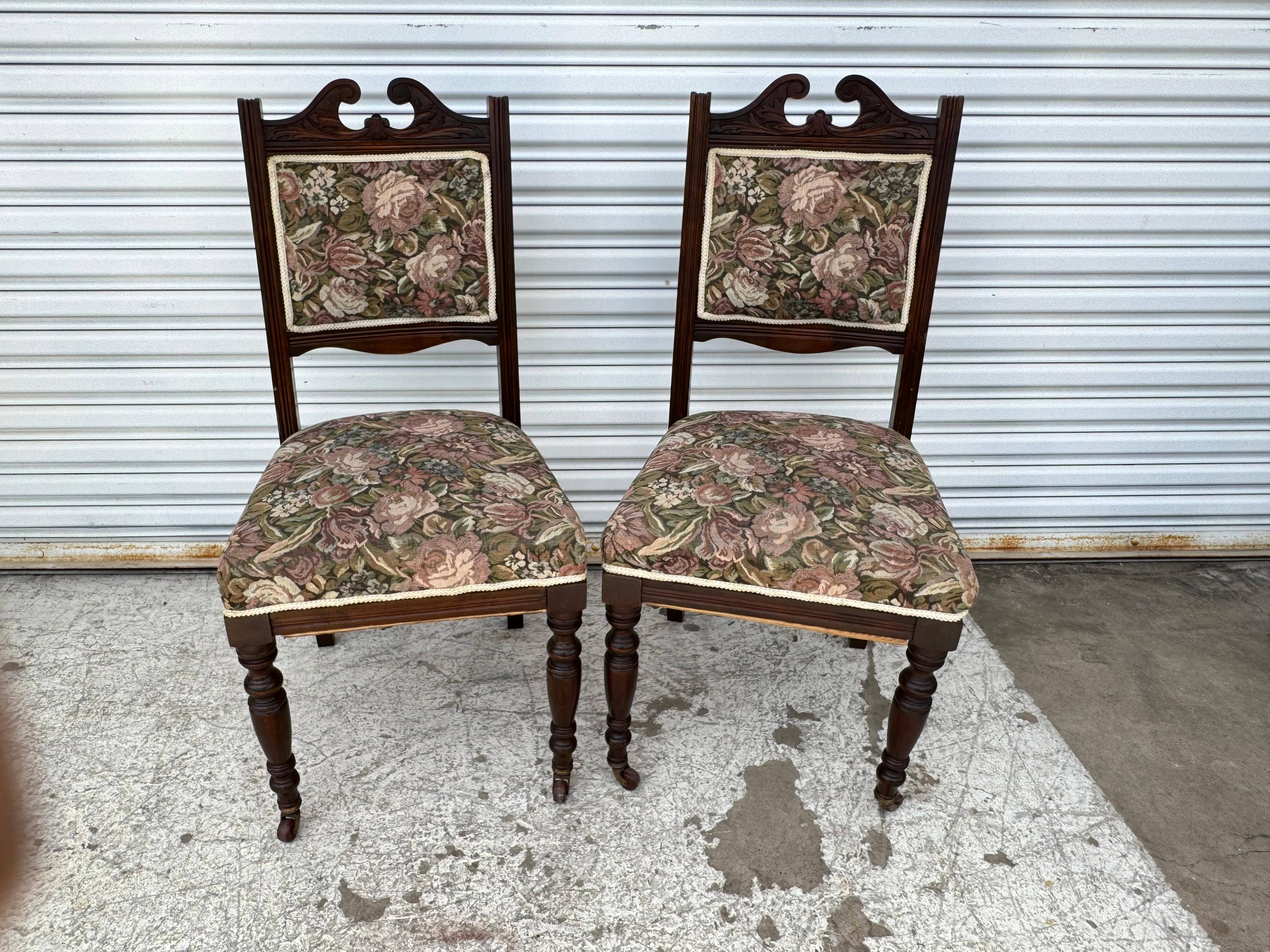 Wood Pair of Victorian Parlor chairs with casters on front legs For Sale