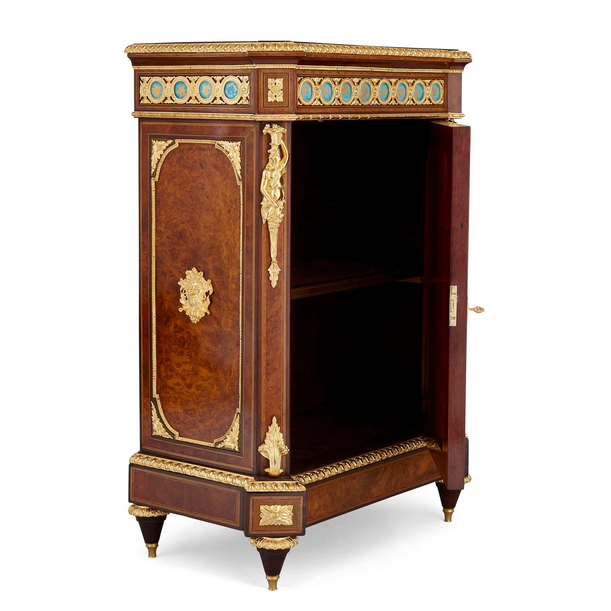 Pair of Victorian period amboyna cabinets with Sèvres style porcelain plaques
English, late 19th century
Dimensions: Height 108cm, width 77cm, depth 47cm

This unusual and superbly crafted pair of cabinets are made from ormolu-mounted amboyna