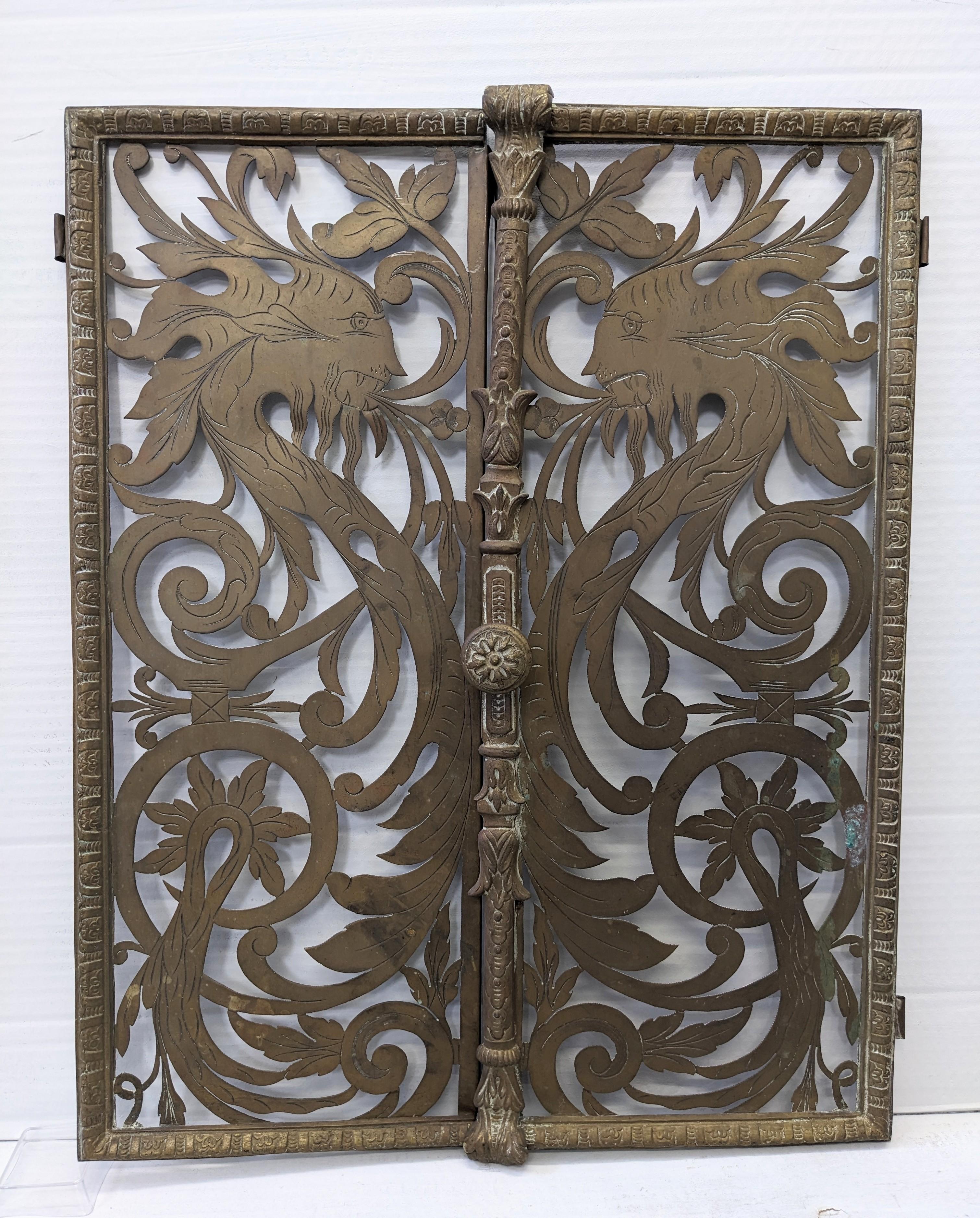 Pair of Victorian Pierced and Etched Brass Griffin Motif Gates from the late 19th Century, designed as openwork panels with swirls and griffins cut into the metal. Would be great repurposed for a pet house!
Panel with knob 9.5