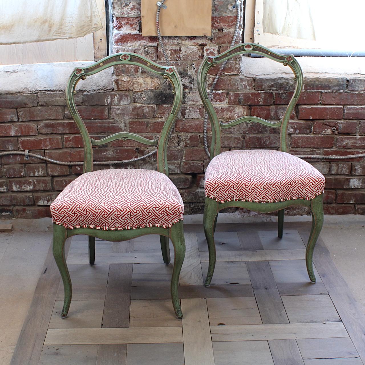 A fine pair of Victorian balloon back side chairs.

With delicate cabriole front legs and a shaped back with medial stretcher.

The chairs have a 20th century faux finish green repaint with red and gold highlights. 

The seats have a new (last