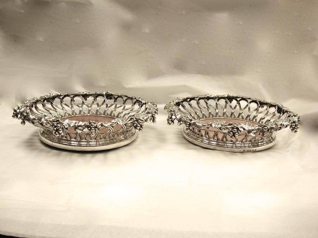 Pair of Victorian silver plated wine coasters with grape and vine leaf decoration.
Made in Birmingham by Elkington and Co and dated circa 1860.
The quality of the cast border and twisted wirework is phenomenal.
You would not get better