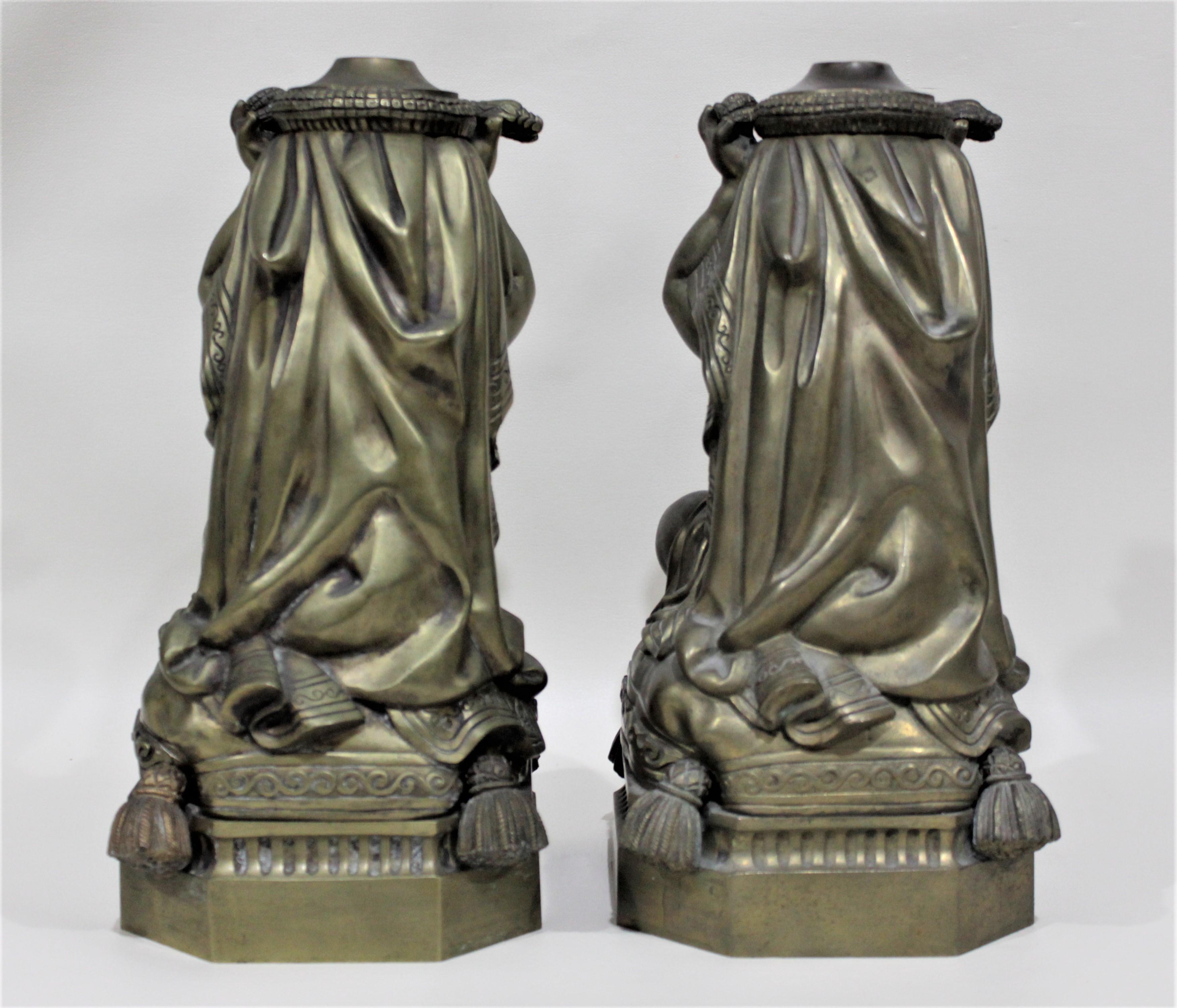 High Victorian Pair of Victorian Solid Cast Bronze Figural Cherub Oil Lamp Bases Holding Snakes For Sale