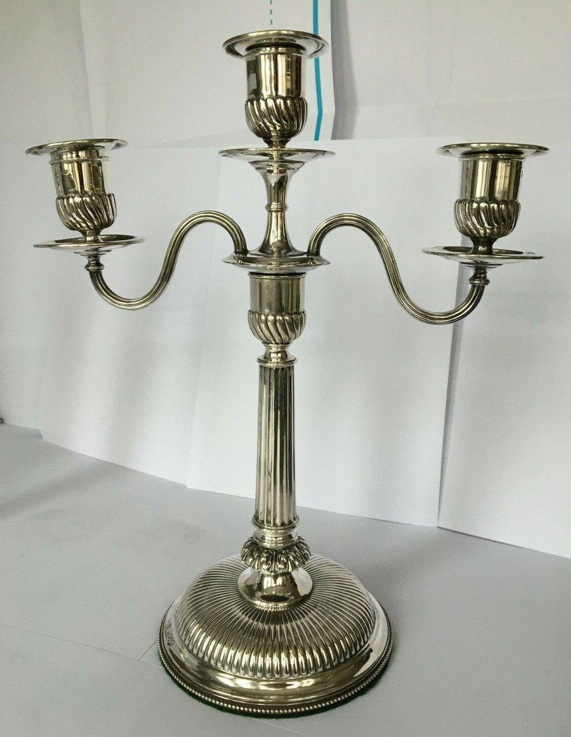 This is a fabulous pair of antique Victorian Sterling Silver, three light, two-branch table Corinthian column candelabra. The candelabra feature detachable sconces for ease of cleaning. The candelabra have filled bases for stability and are covered