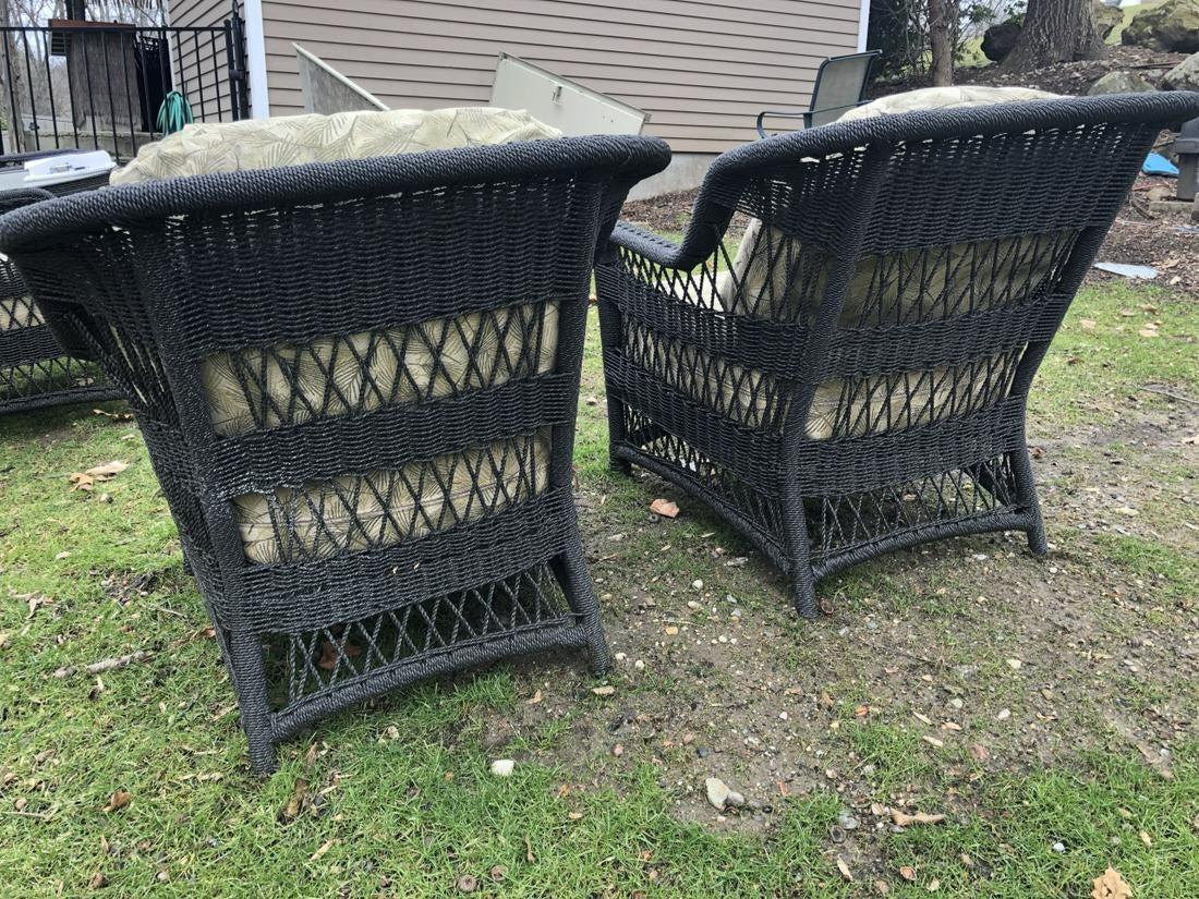 Pair of outdoor wicker arm chairs made of weather proof synthetic wicker. Great for garden or porch. Cushions have removable and washable covers.
