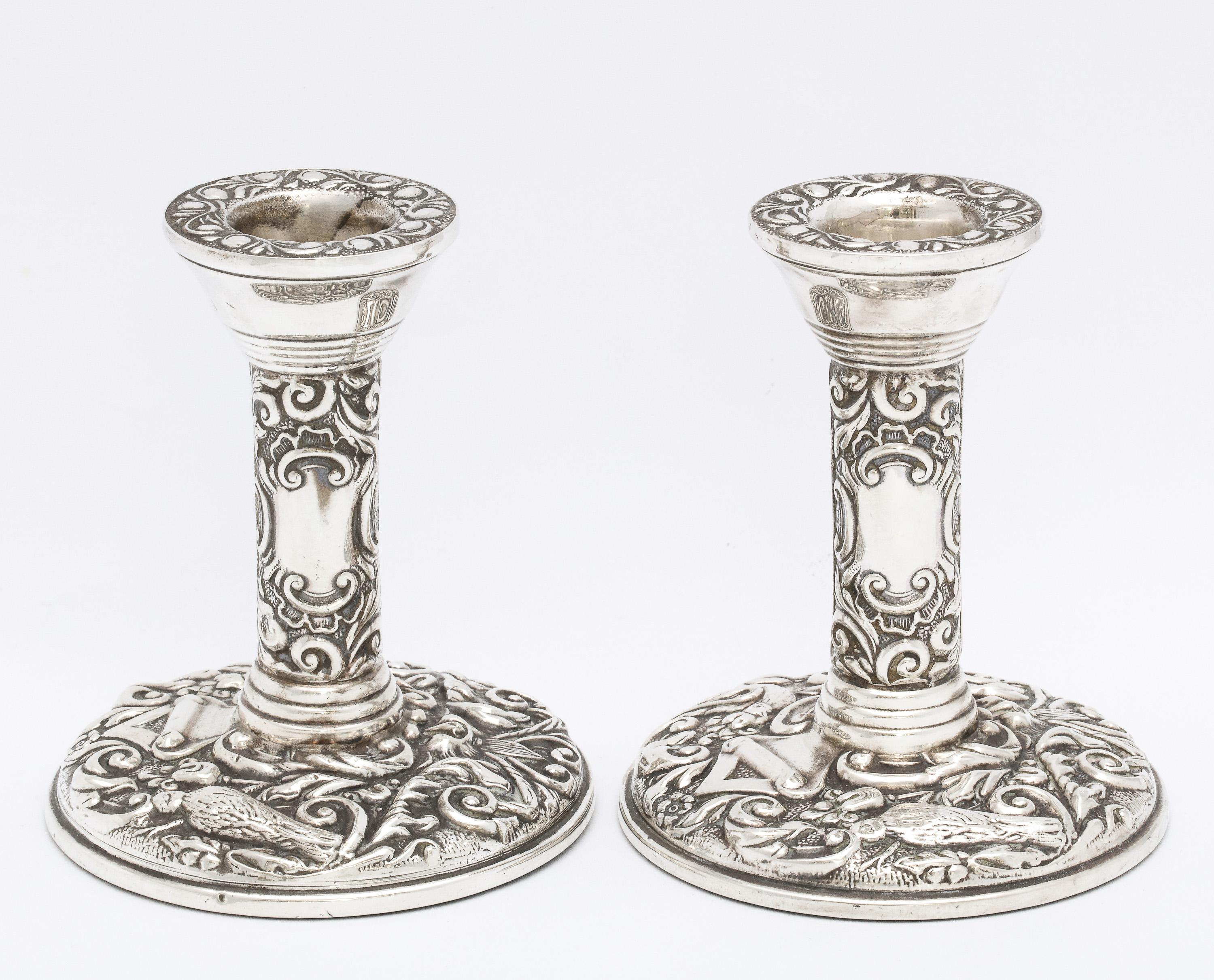 Pair of Victorian style, sterling silver candlesticks, Birmingham, England, Broadway and Company, year-hallmarked for 1977 for Queen Elizabeth II 's Jubilee. Designed with birds, swirls, etc. Each candlestick measures 4 inches high x 3 1/2 inches