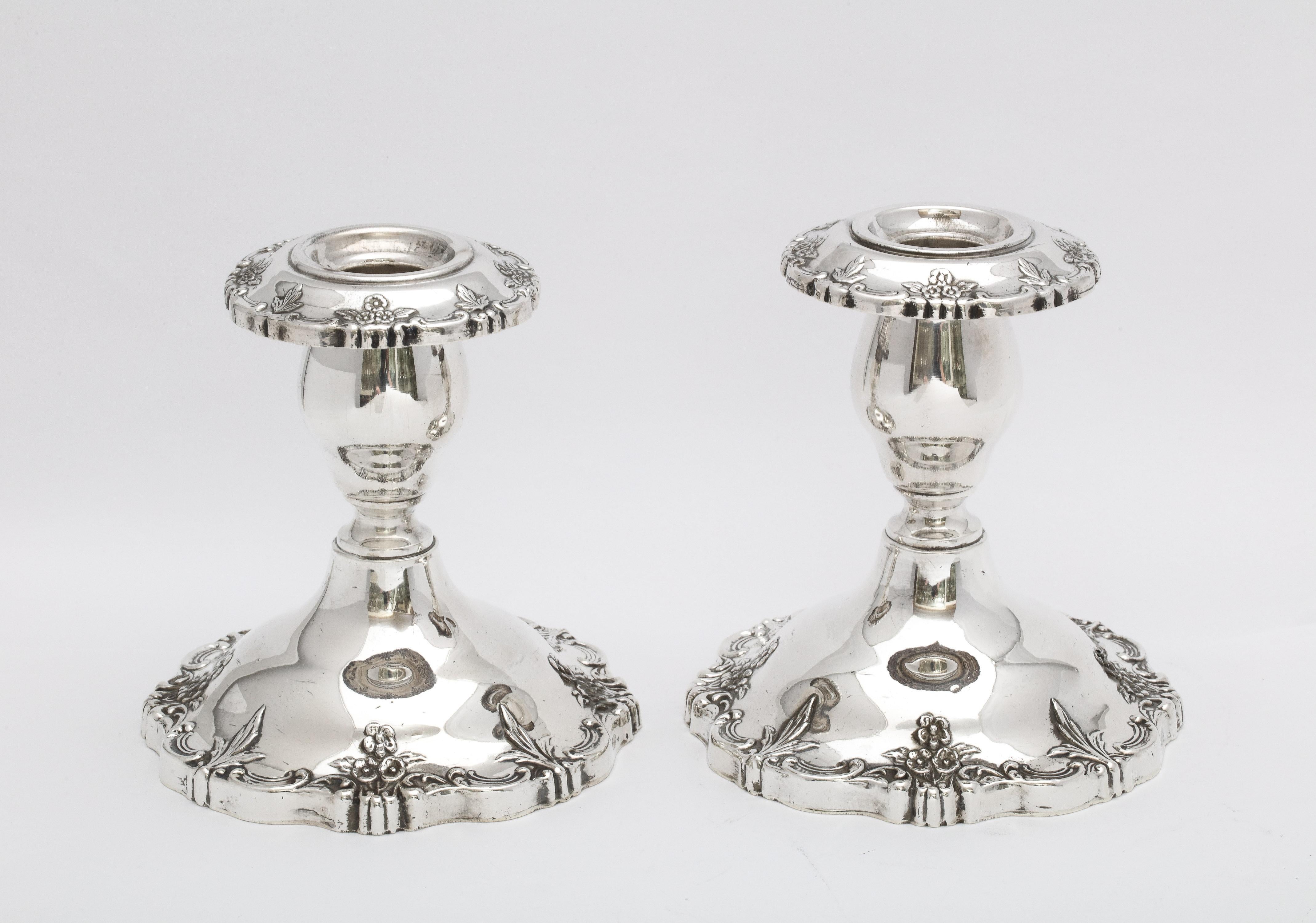 Pair of Victorian-Style, sterling silver candlesticks, Fisher Silversmiths, Inc., Jersey City, New Jersey, Ca. 1935. Each candlestick measures 5 inches high x a little under 4 3/4 inches diameter across base (widest point). Pair is weighted. Floral