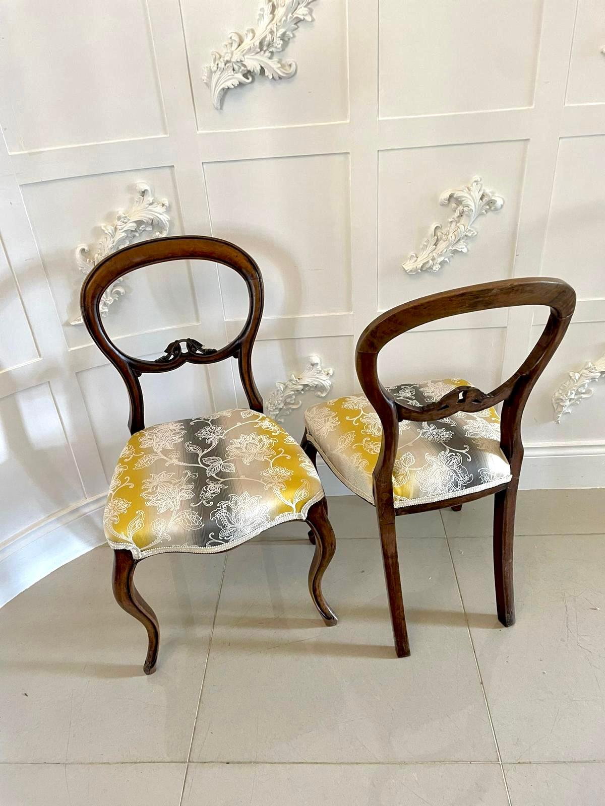 Pair of 19th century Victorian antique walnut bedroom/side chairs having a pretty balloon back with carved lower rail and serpentine seat. They stand on elegantly shaped cabriole legs to the front out swept back legs. Newly recovered in a quality