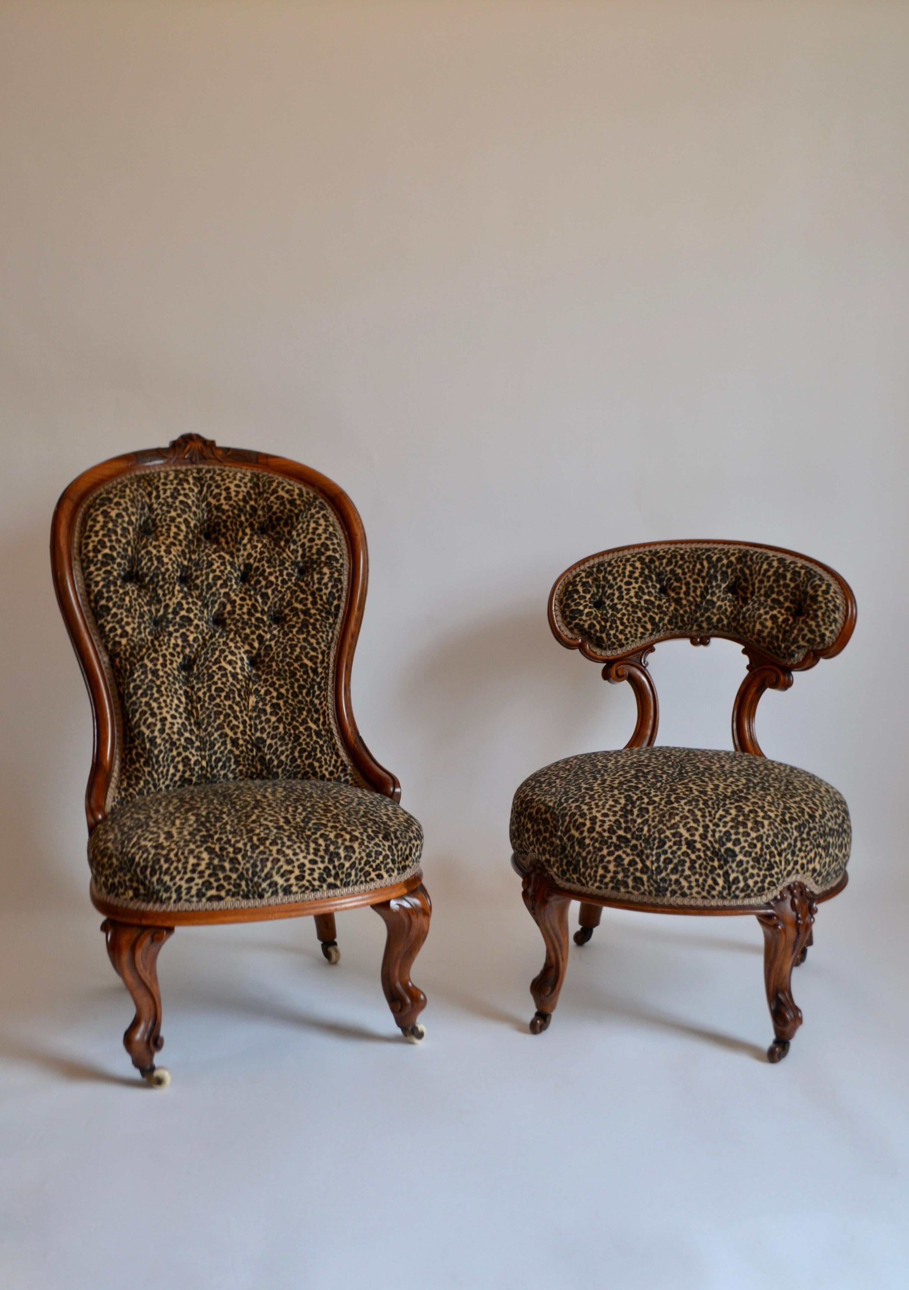 A Victorian stained walnut spoon-back nursing chair on cabriole supports to castors and an early Victorian walnut nursing chair with curved tablet back on round sprung seat, raised on cabriole supports. Both reupholstered in faux leopard skin.