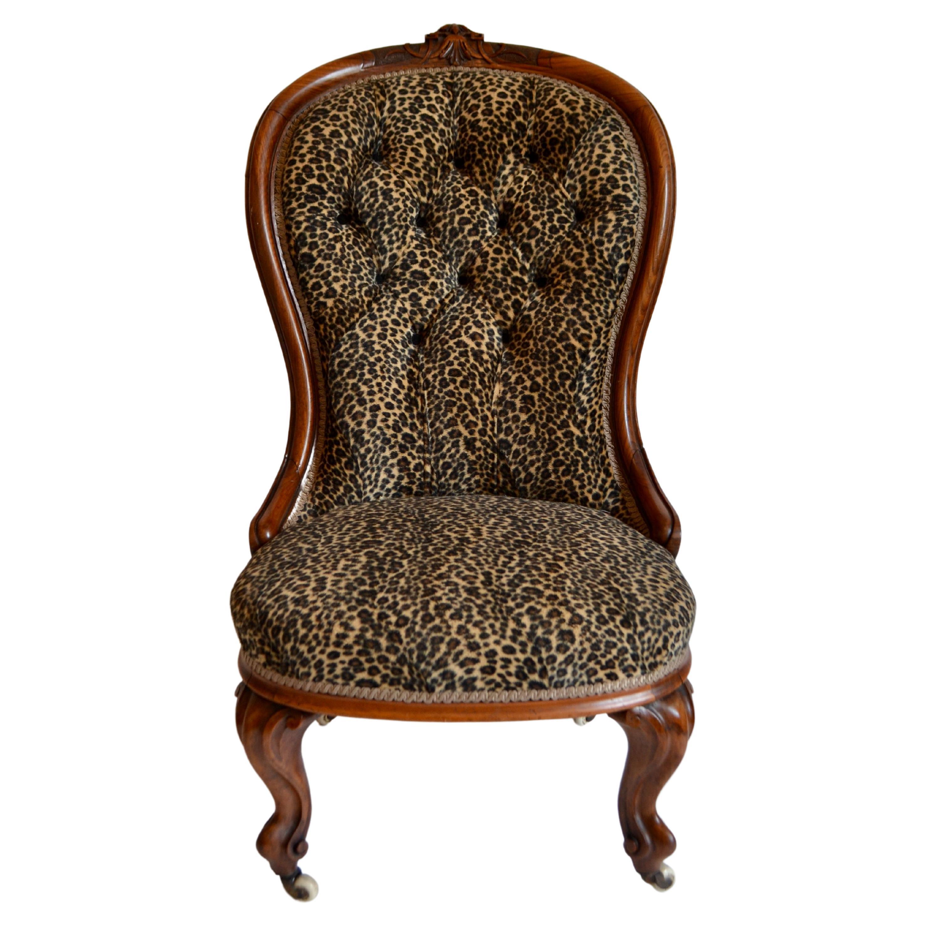 A Victorian stained walnut spoon-back nursing chair on cabriole supports to castors and an early Victorian walnut nursing chair with curved tablet back on round sprung seat, raised on cabriole supports. Both reupholstered in faux leopard