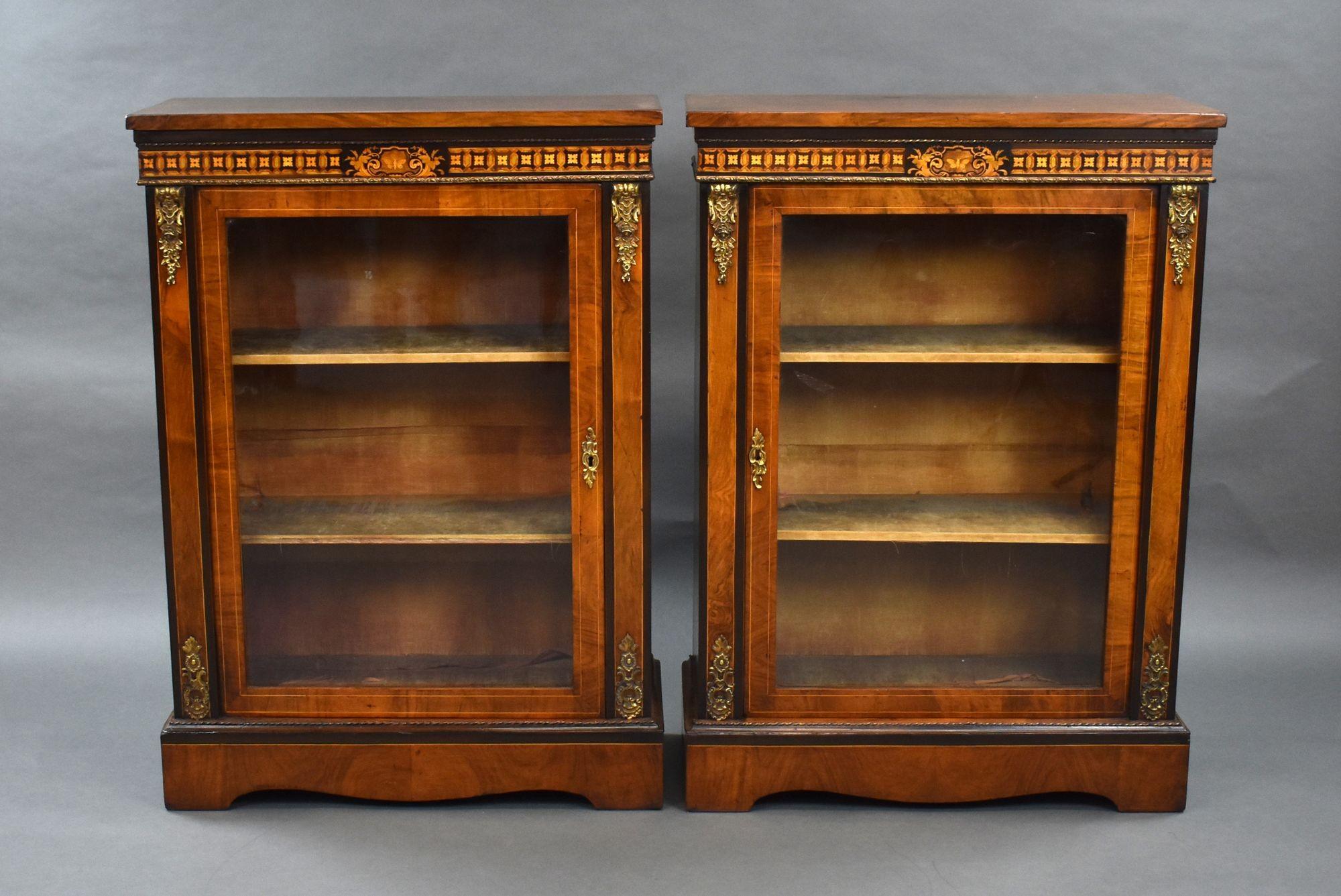 For sale is a pair of good quality Victorian walnut inlaid pier cabinets, each having a single glazed door, opening to two shelves. The cabinets are decorated with inlay and brass mounts throughout and both remain in very good condition.