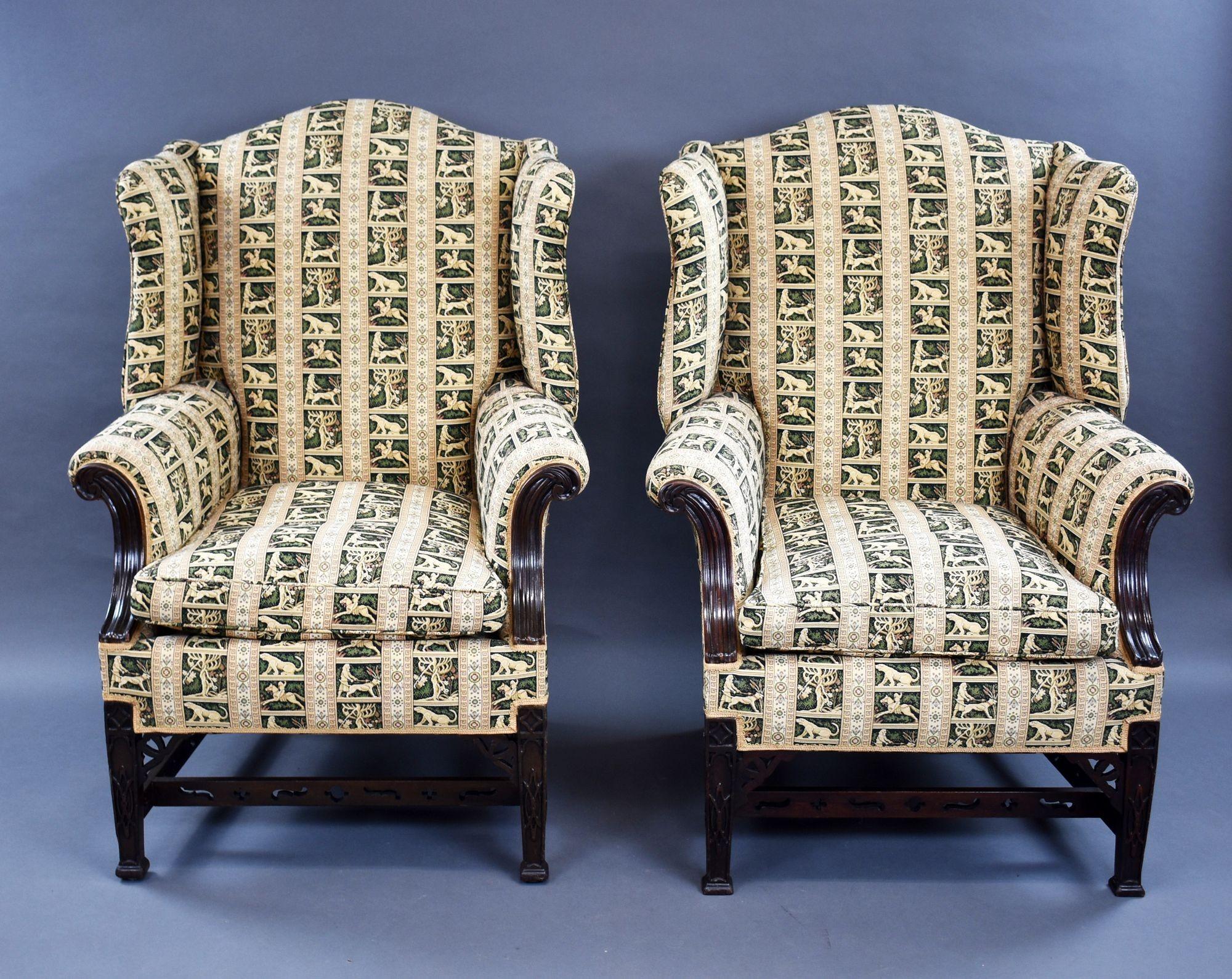 For sale is a good quality pair of Victorian mahogany Chippendale style wing back armchairs. Upholstered in a fine tapestry fabric, the chairs stand on carved Chippendale style legs united by stretchers. Both chairs are structurally sound and the