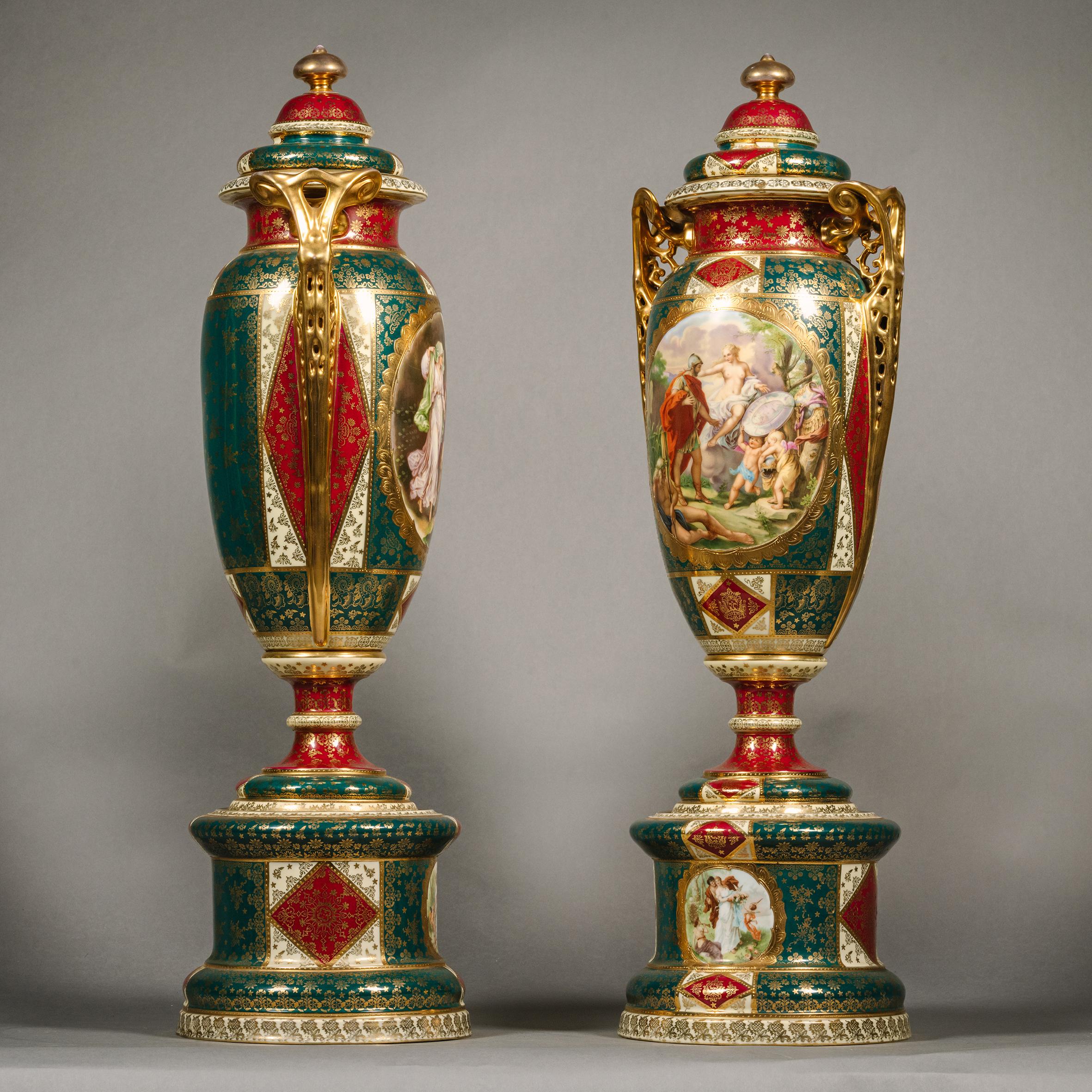 A Large Pair of Vienna Style Porcelain Vases and Covers.

Each of tapering baluster shape decorated with gilt flowers and anthemion against a claret and ivy green ground. The front with finely painted reserves depicting classical scenes of  Minerva