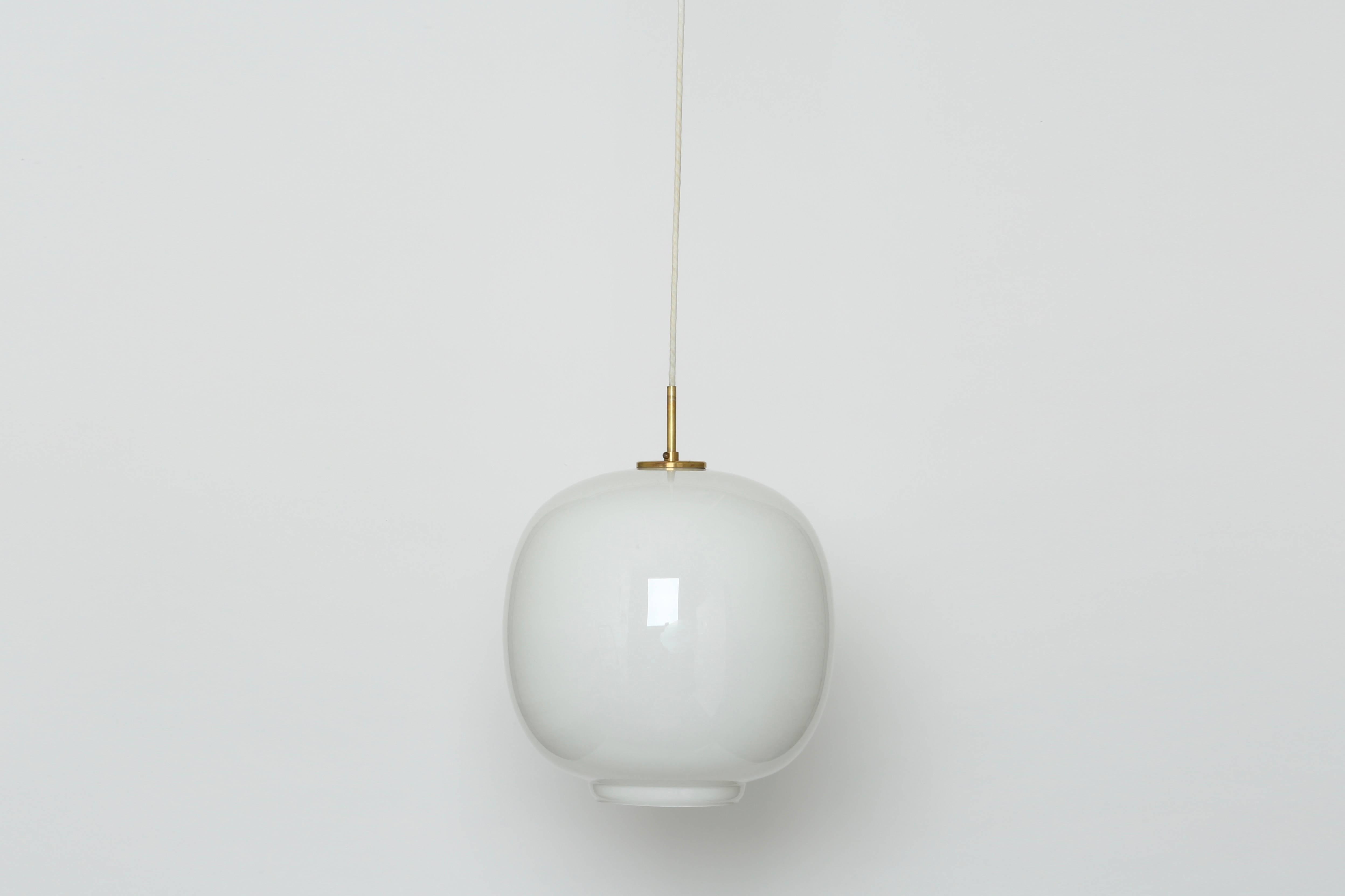 A pair of ceiling pendants by Vilhelm Lauritzen for Louis Poulsen.
These pendants were made in three different sizes. 
This is the largest size with 14.75 inches in diameter.
Danish architect Vilhelm Lauritzen designed these pendants for Radio