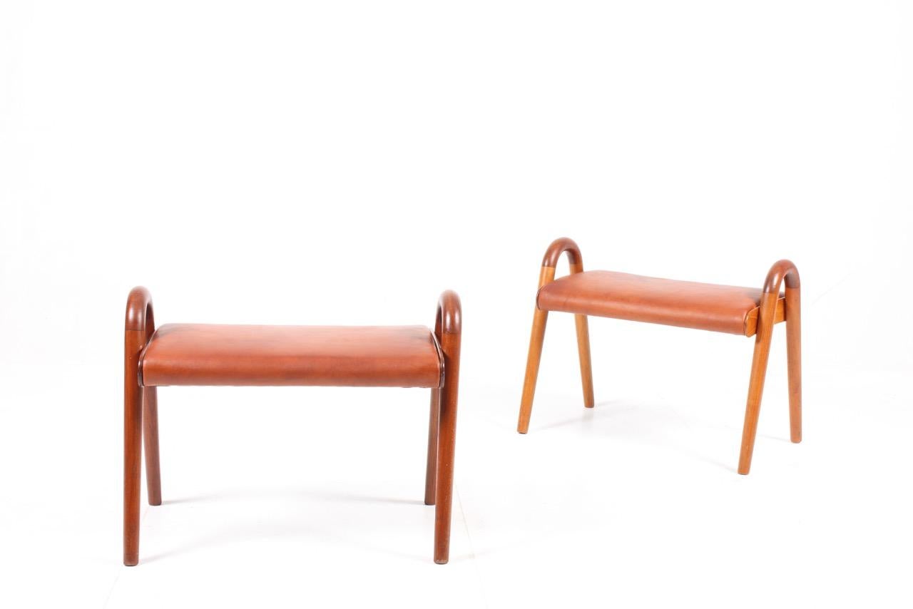 Pair of stools in solid teak with seat in patinated leather. Designed by Vilhelm Lauritzen Denmark, 1950s.
 