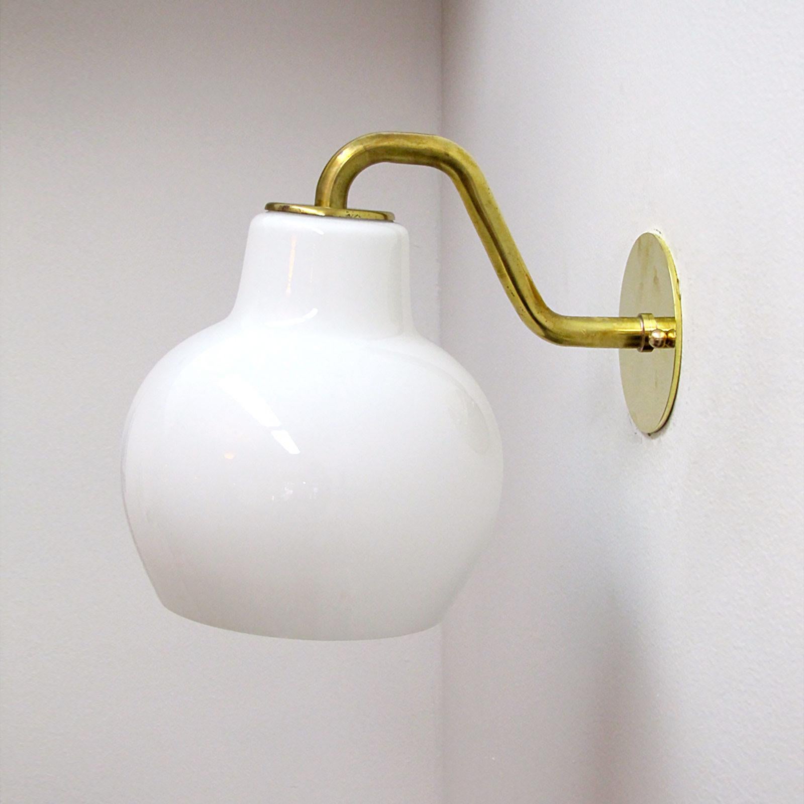 Elegant early pair of wall lights by Vilhelm Lauritzen for Louis Poulsen, with opaline glass shade on brass hardware, wired for US standards, one E27 socket per fixture, max. wattage 75w, bulbs provided as a one time courtesy.