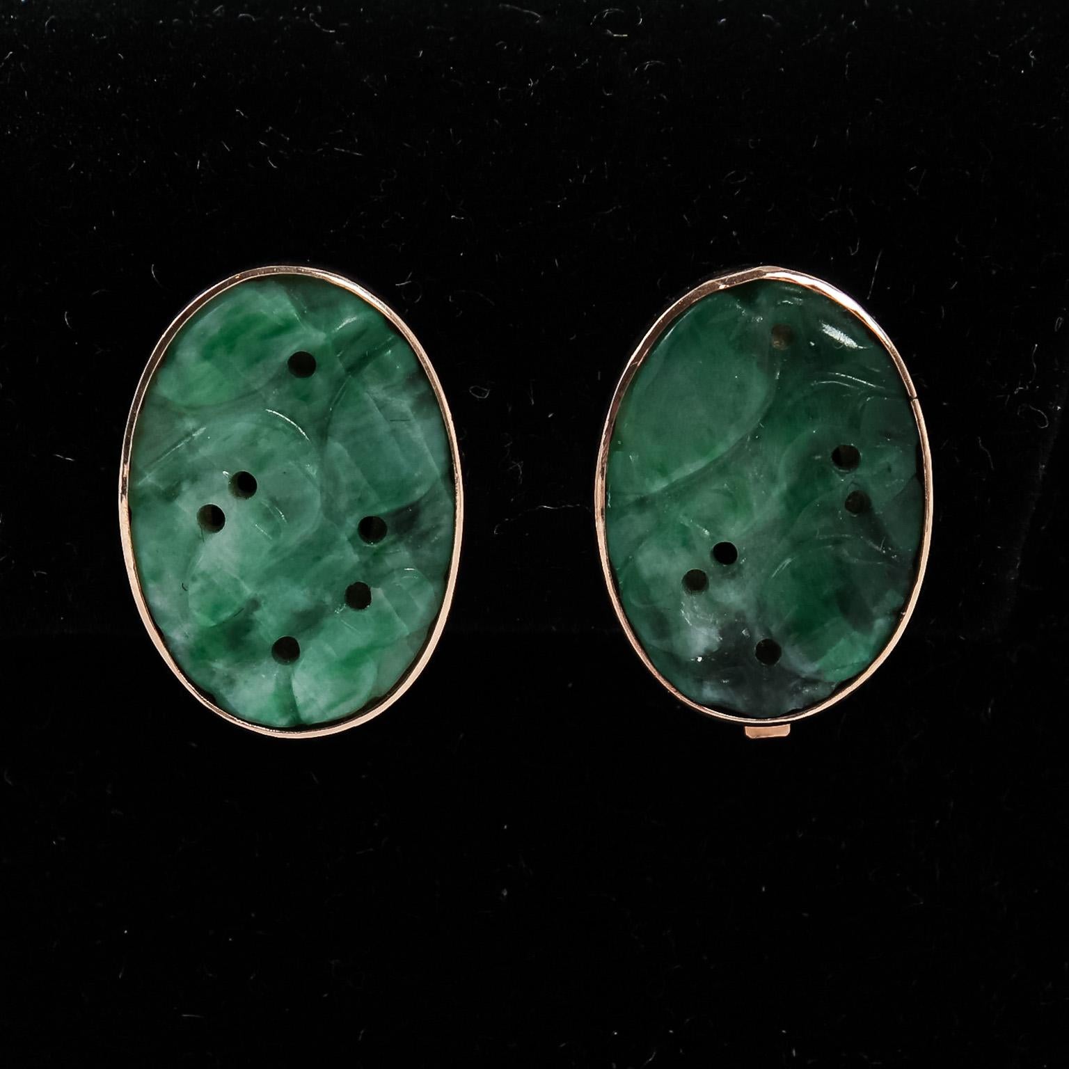 Circa 1960-1970s Pair of vintage clip on earrings constructed from solid 14 karat yellow gold. The stones are hand carved natural jadeite jade, most likely from China and made about 100 years ago. Signed 14K with a designer's mark that is not