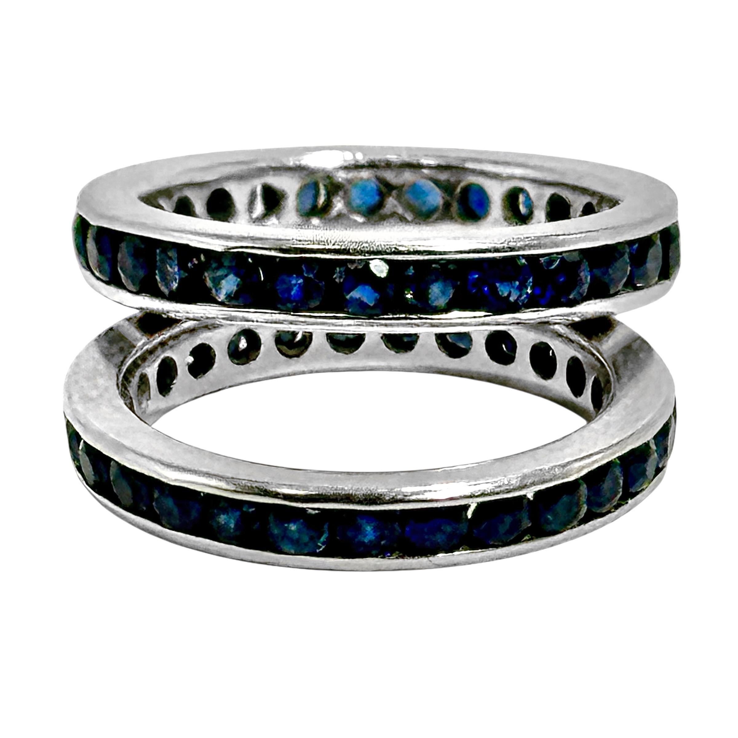 This lovely pair of vintage 18K white gold and sapphire eternity bands would be a welcome addition to your jewelry collection (that is only if your ring size is 5 1/2).  The bands are set with a total of approximately 56 round faceted, natural blue
