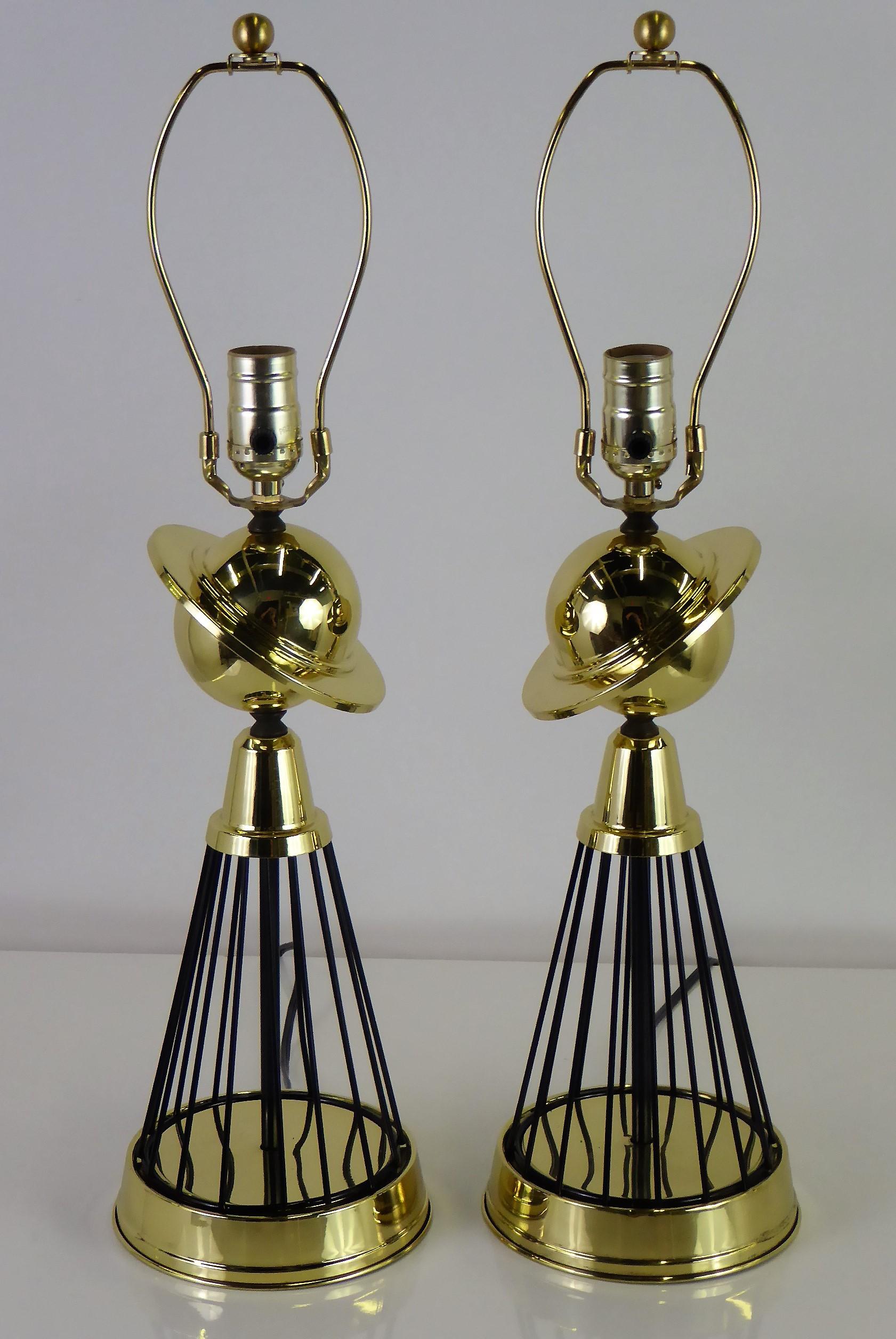Spectacular pair of 1940s brass and black wire table Lamps with a Saturn motif. Re-brassed and re-lacquered, they are in perfect order with new wiring and new UL three level sockets, medium base. Fully restored. Shades shown as examples, just add