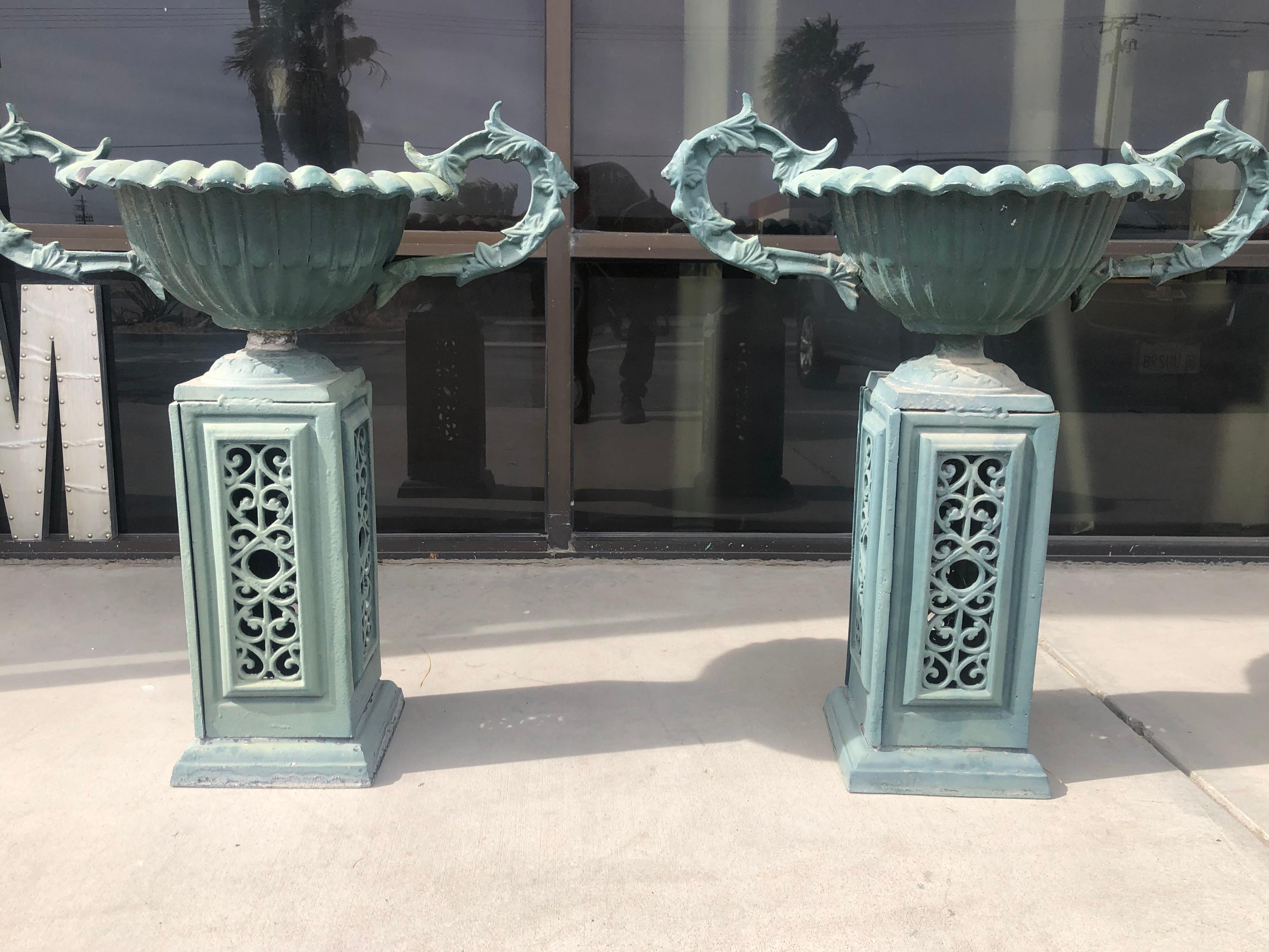 These pair of metal jardinieres aka “Vasa Chambord”, very much in the style of Bridgerton came from a chic Hollywood Regency style Palm Springs area estate. They obtain their original verdigris color. Could be easily touched up inside potting urns