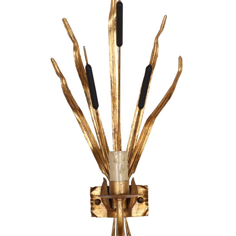 Pair of Maison Baguès style, single light, tole wall sconces. Produced in Paris in the 1950s. Each light in the decorative representation of bullrushes and reeds.
This tole wall sconce wears its original gold leaf gilding with a beautifully