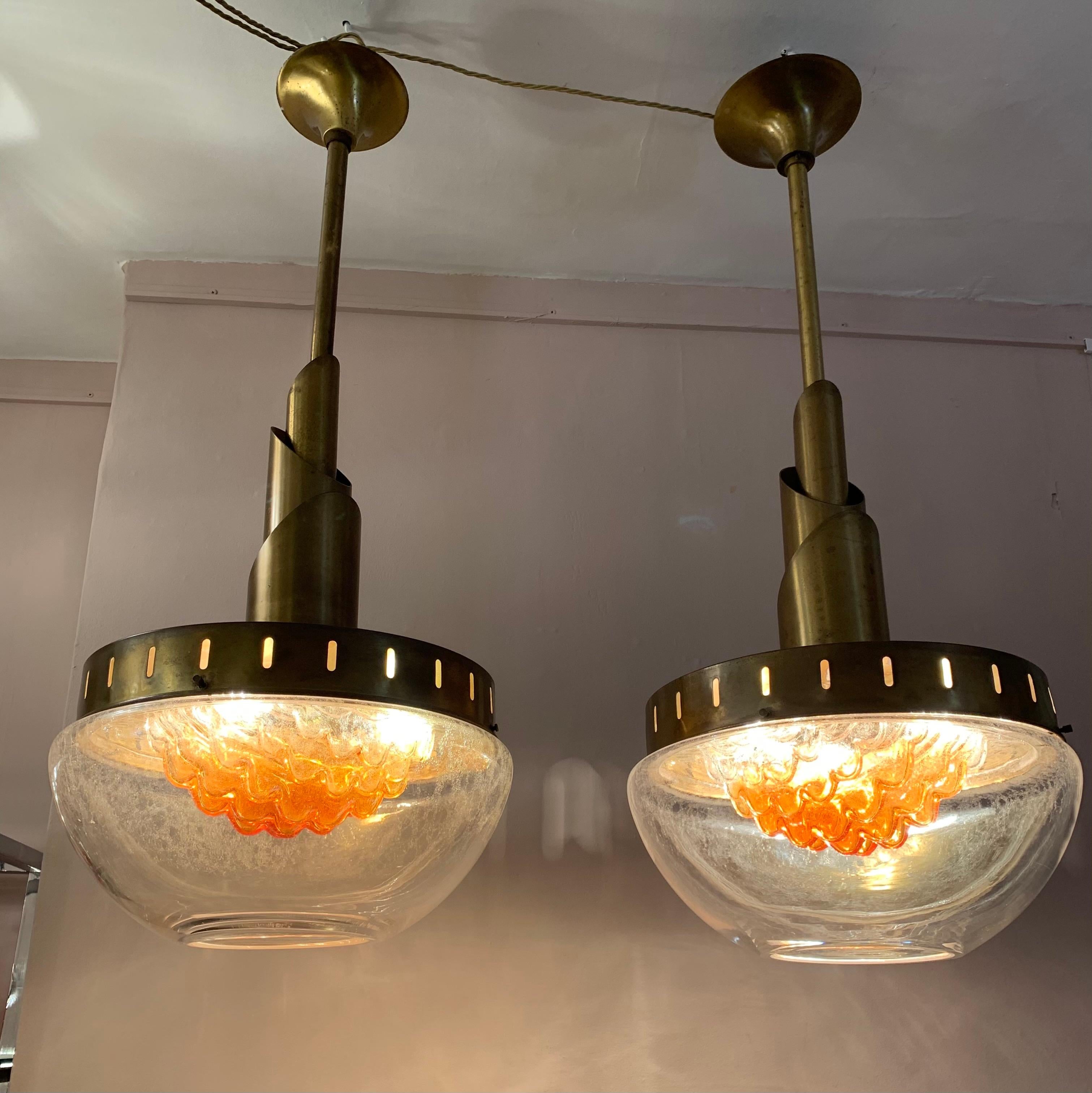Stunning pair of rare large 1960s Murano glass hanging pendant lights manufactured by Mazzega. Designed by Carlo Nason. The lights are formed to resemble upturned torches with the glass simulating the flames from a lit torch. The patina of the brass