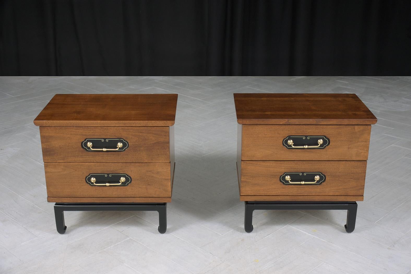Step back into the stylish era of the 1960s with this exceptional pair of American of Martinsville nightstands, masterfully hand-crafted from walnut wood and brought back to life with a full restoration and refinishing by our dedicated professional