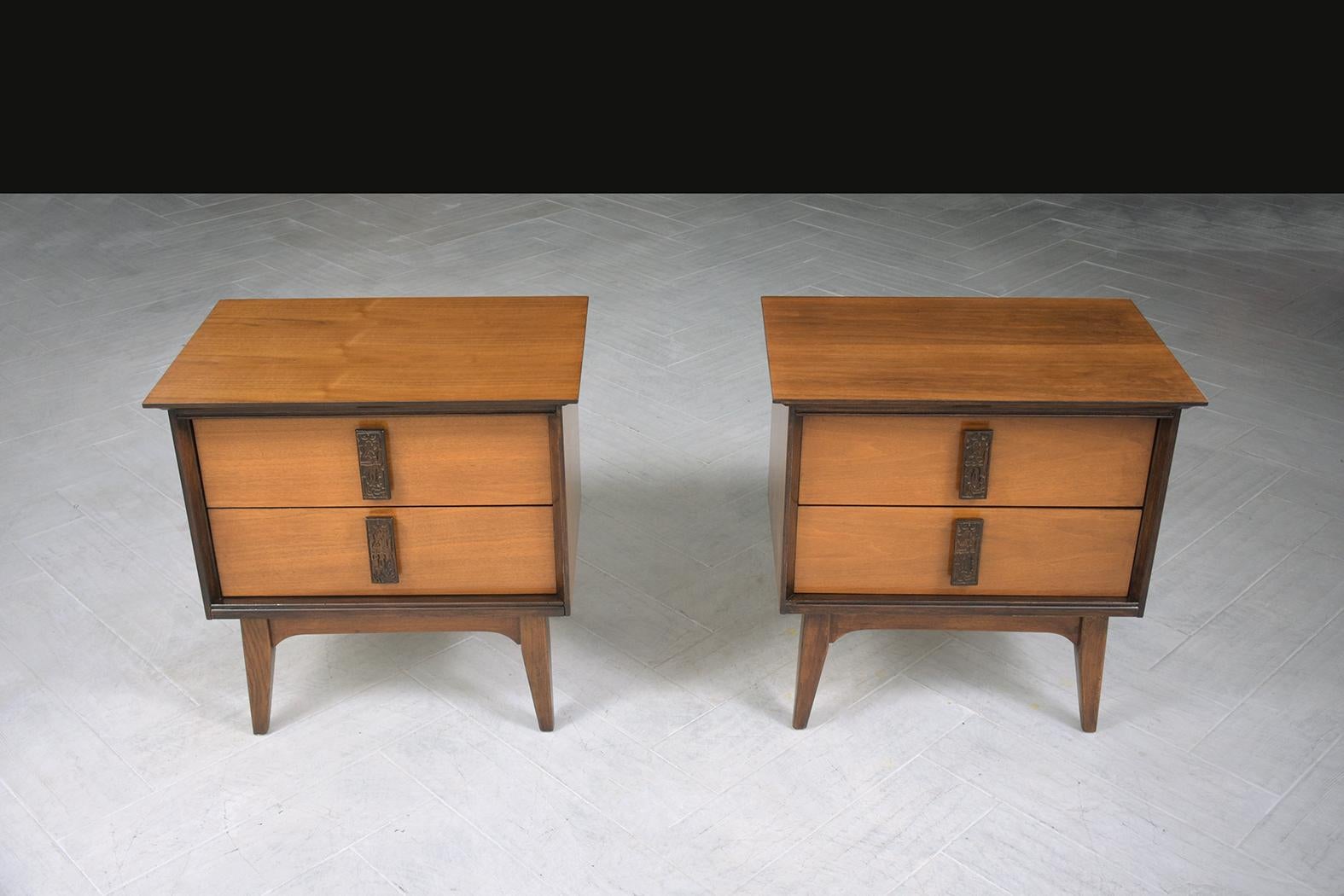 An extraordinary pair of 1960s American Martinsville nightstands are hand-crafted out of walnut and are in great condition and completely restored and refinished by our professional craftsmen team. These mid-century modern bedside tables are