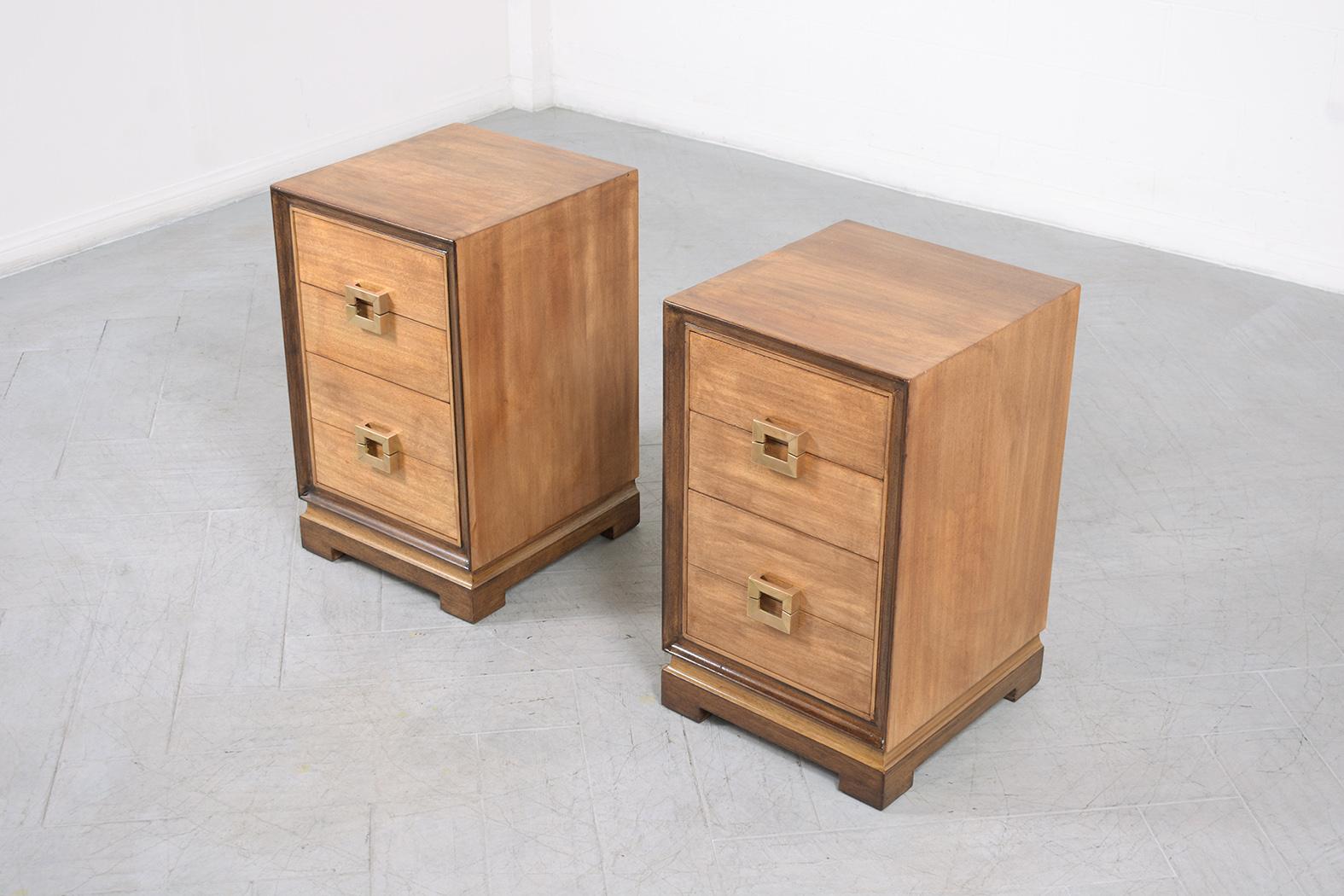 An extraordinary pair of vintage 1960s mid-century modern nightstands that are in great condition beautifully crafted out of wood that has been completely restored by our in-house professional craftsmen team. This sleek pair of 1960s bedside tables