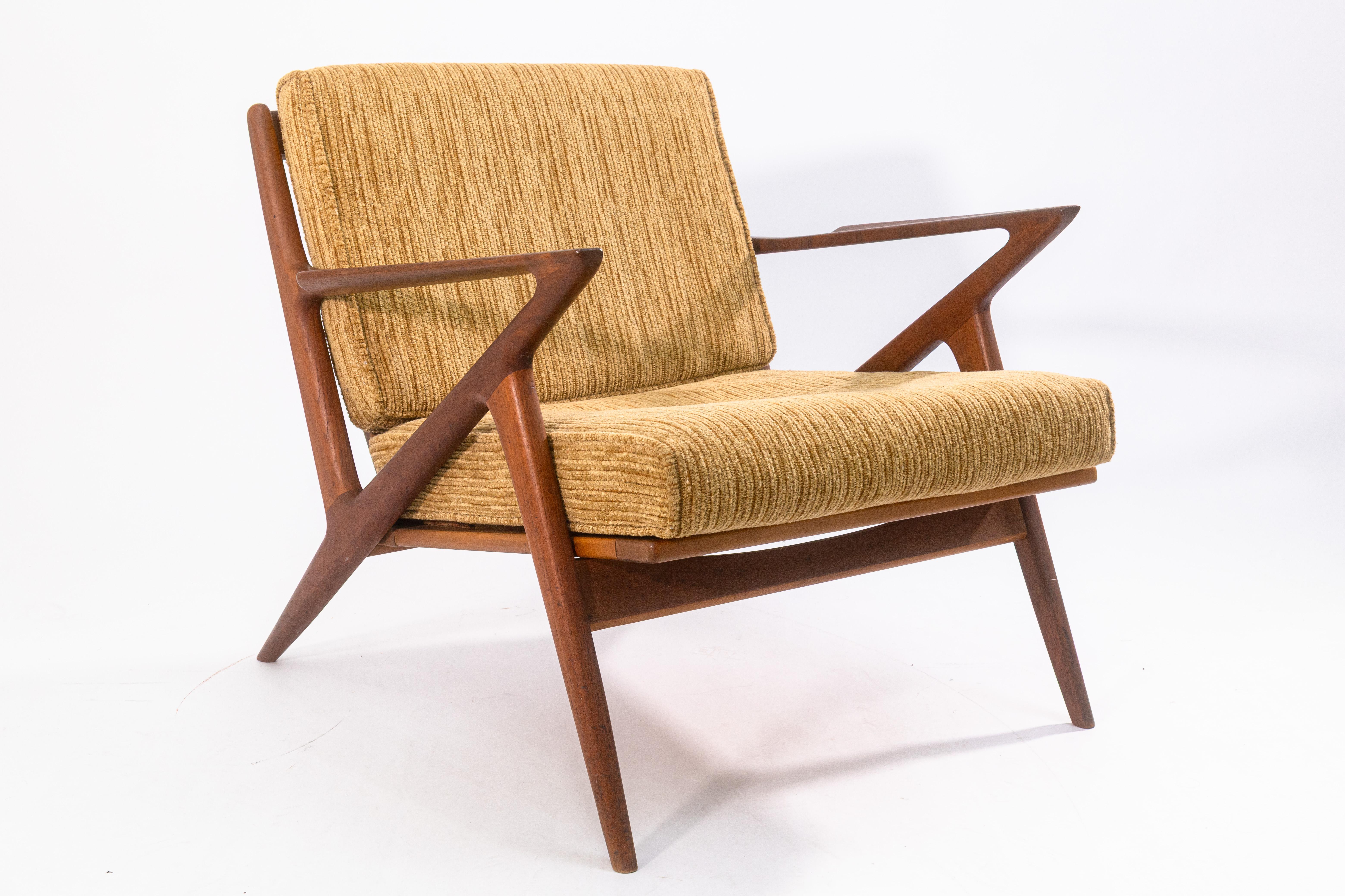 A pair of vintage Poul Jensen for Selig Z armchairs. This is a gorgeous set of original 1960s Z chairs by Poul Jensen, featuring a beautiful teak wood construction and brown and beige fabric upholstery cushions. The Z chair was originally created by