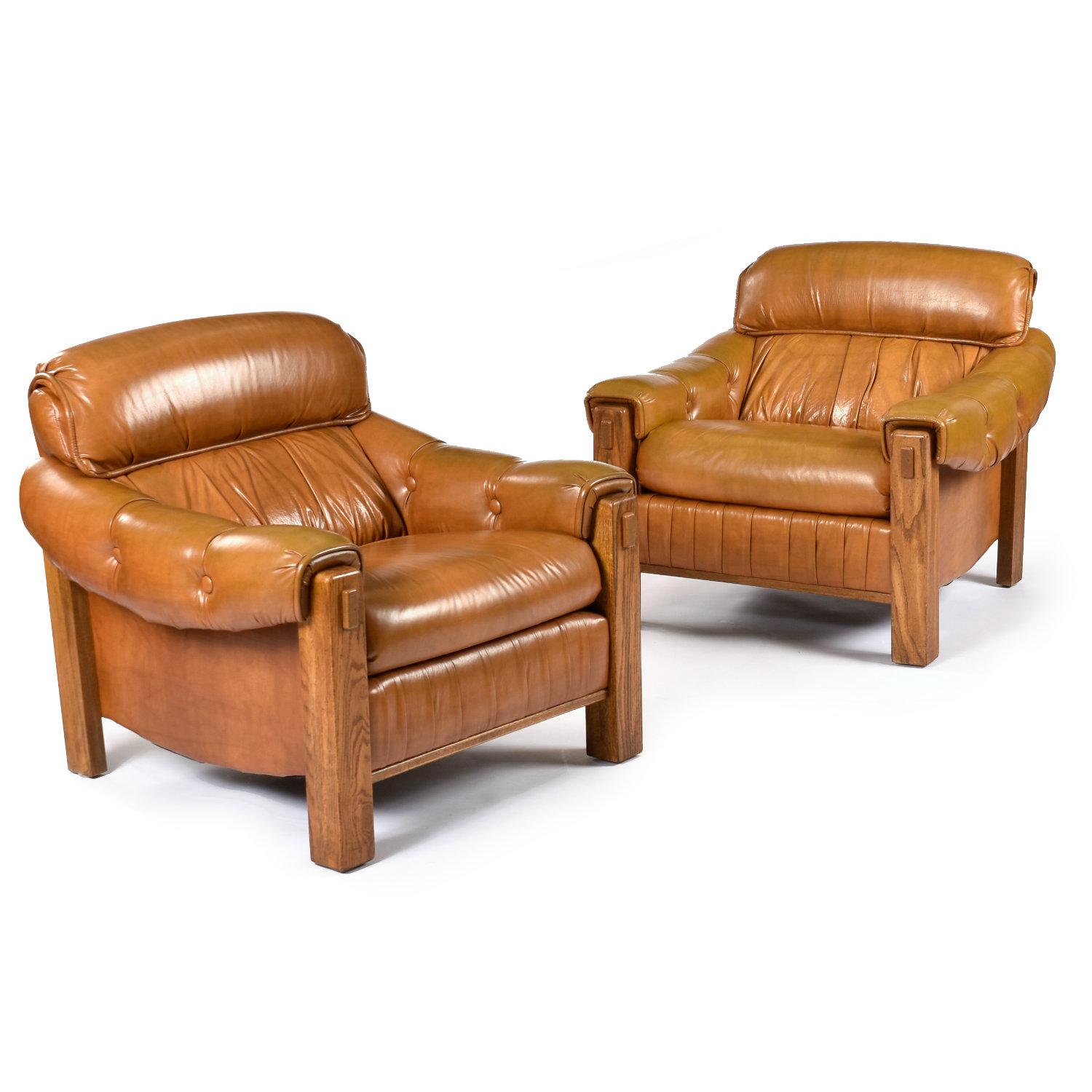 Sit back and relax in these amply stuffed vintage 1970s club chairs. The pair of armchairs have robust solid oak frames with a distinctive Nineteen-Laties flyspeck finish. The generously stuffed chairs perfectly suit today’s level of comfort. These