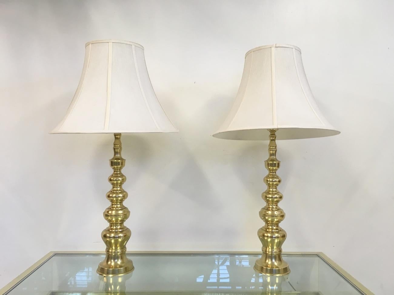 A pair of brass table lamps
Original shades
1970s
Height with shade is 90cm.
