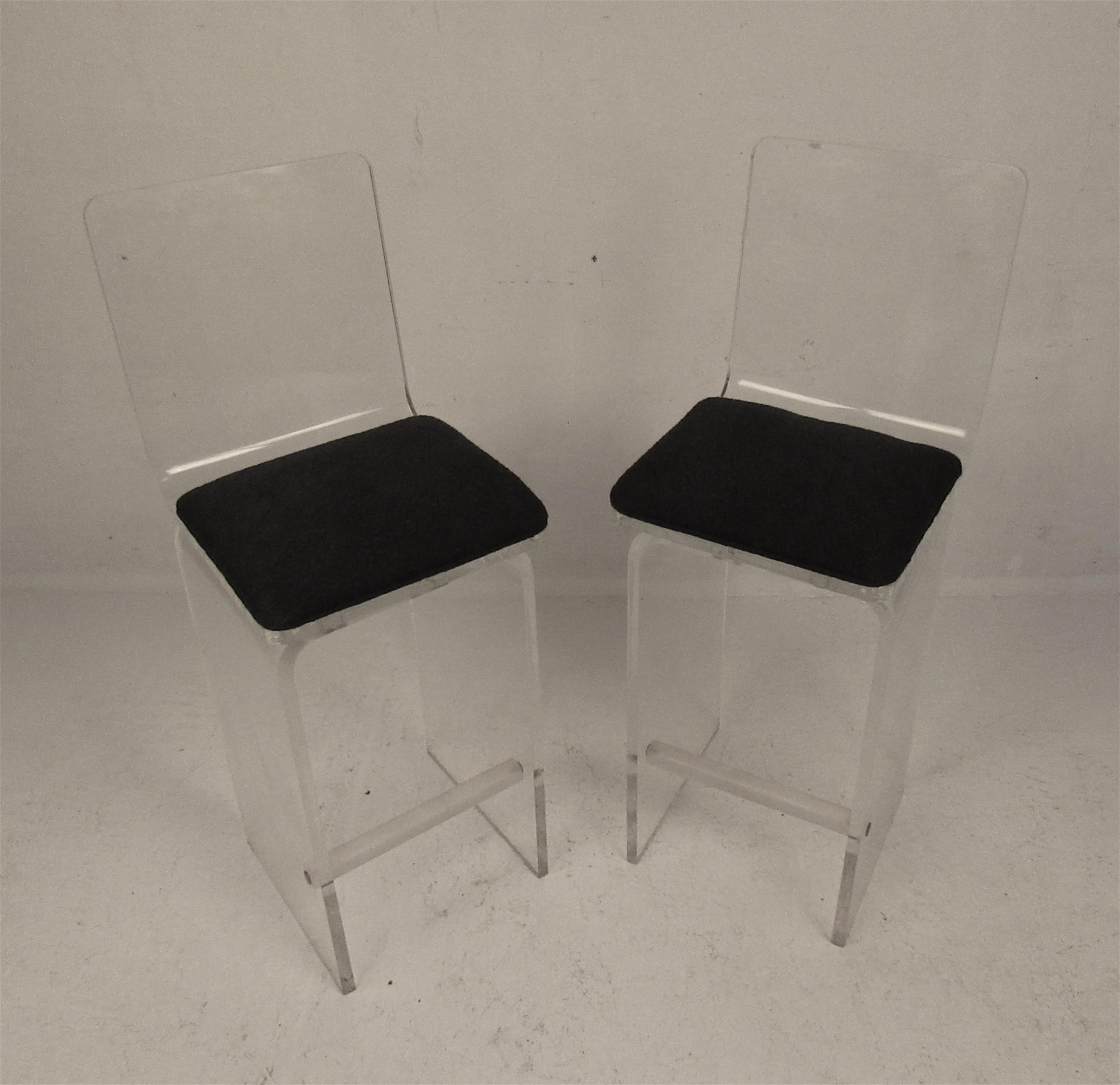 This beautiful pair of Mid-Century Modern bar stools boast a heavy Lucite frame with an overstuffed cushion. A lovely swivel design that provides plenty of comfort without sacrificing style. Please confirm the item location (NY or NJ).