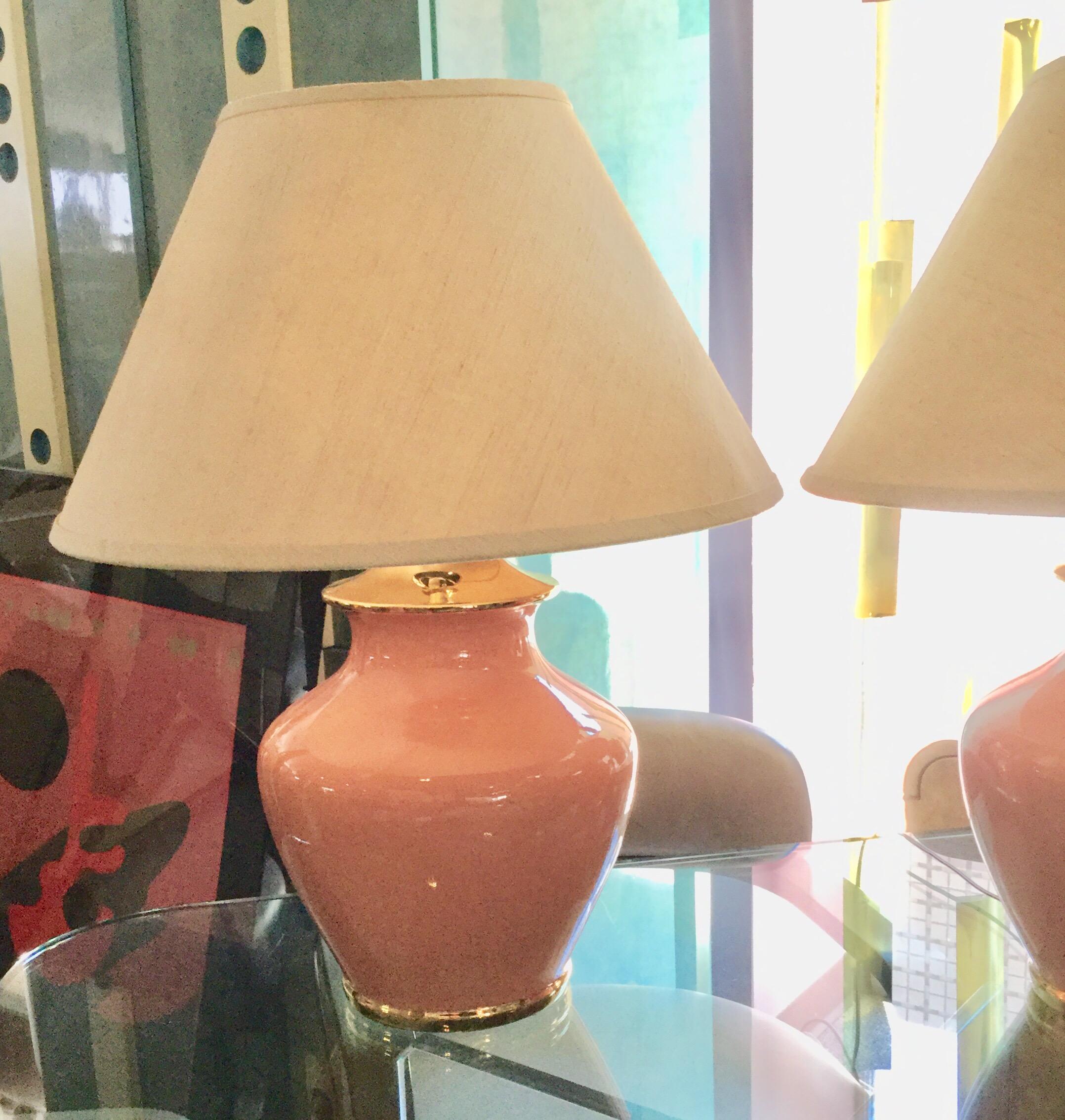 These are a pair of very glamorous Lamps from the vintage Palm Springs house designed it with great style in the early 1980s. The ceramic is a very desirable in current coral color with metallic gold ceramic trim. These beautiful lamps obtain their