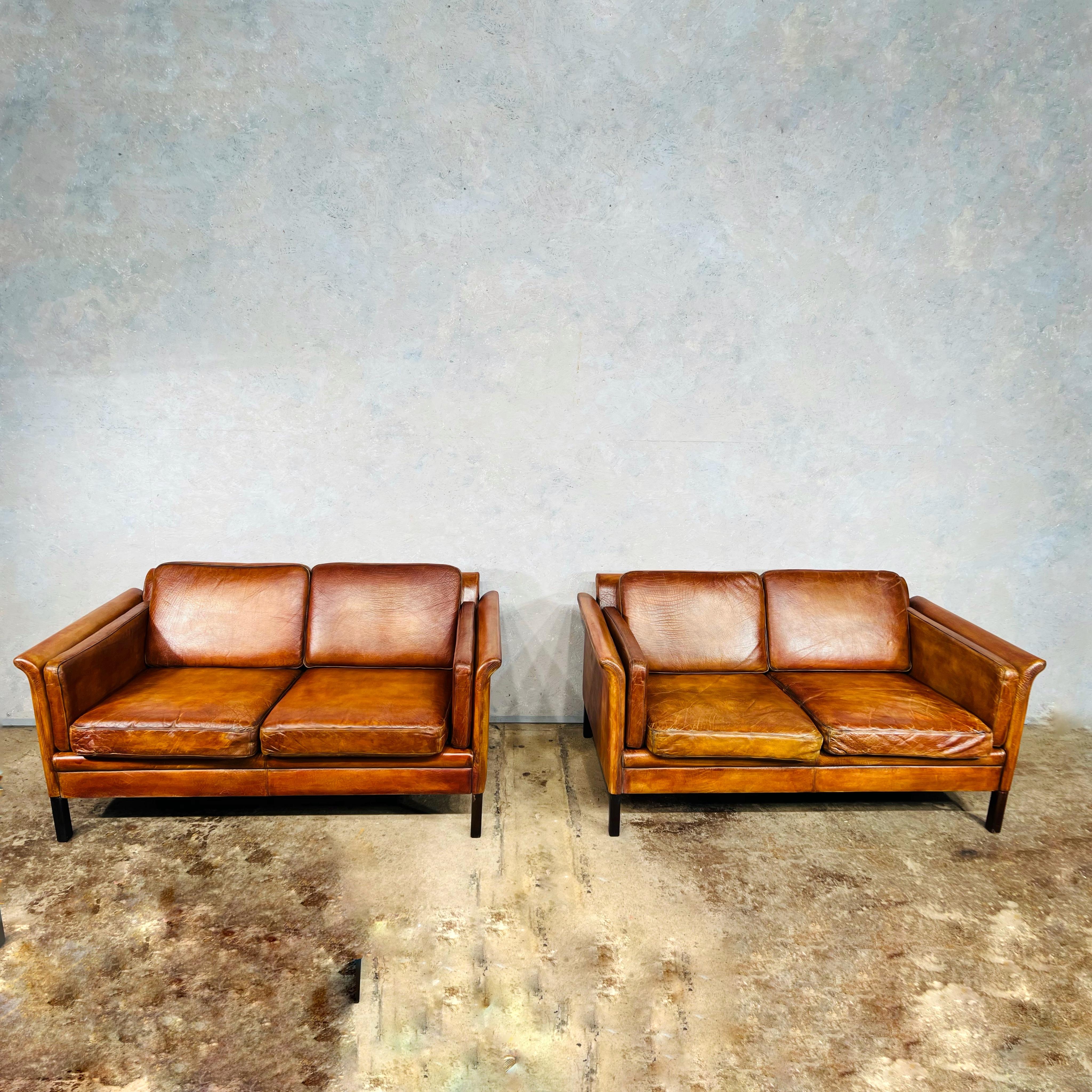 A pair of stylish and neat Danish 1970s sofa, great design with slanted back, very comfortable to sit in.

The leather is great quality, deeply grained, with a beautiful tan colour, patina and finish.

Viewings welcome at our showroom in Lewes,