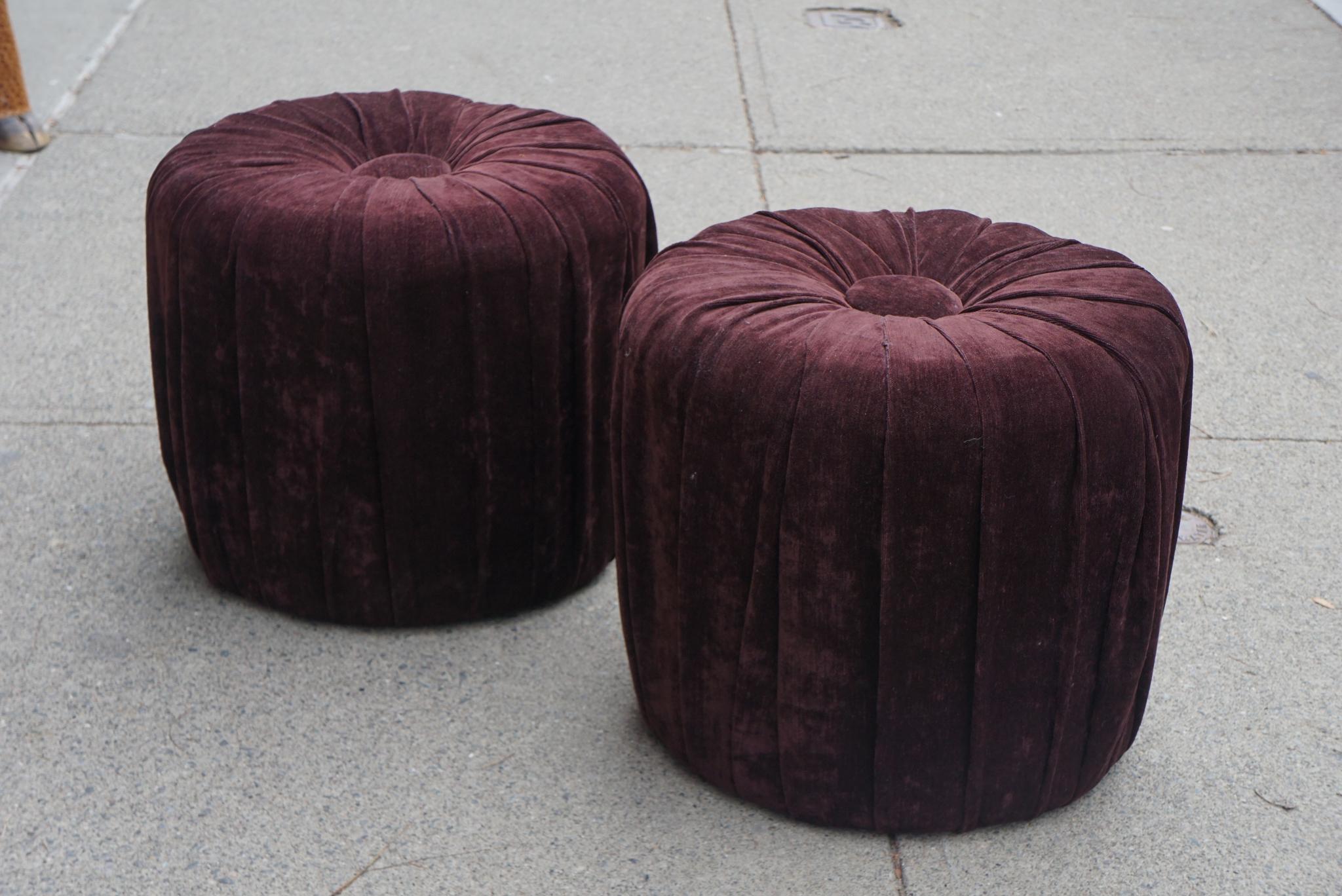 This pair of vintage puffs are upholstered in a rich purple velvet. Hip but practical they can rest grouped under a console or as a color splash in the corners of a room. Made circa the mid 1970s these are perfect small seating used at parties or as