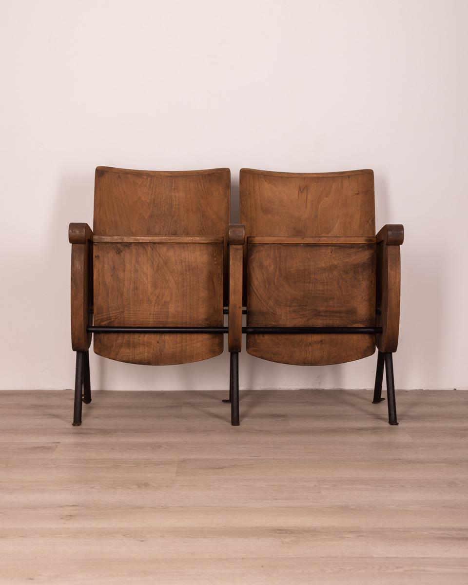 Pair of cinema chairs with black metal structure and wooden seat, 1970s.

Conditions: In good condition, it shows signs of wear given by time.
Dimensions: Height 81 cm; Width 105 cm; Length 50 cm
Materials: Wood and metal
Year Of Production: Anni