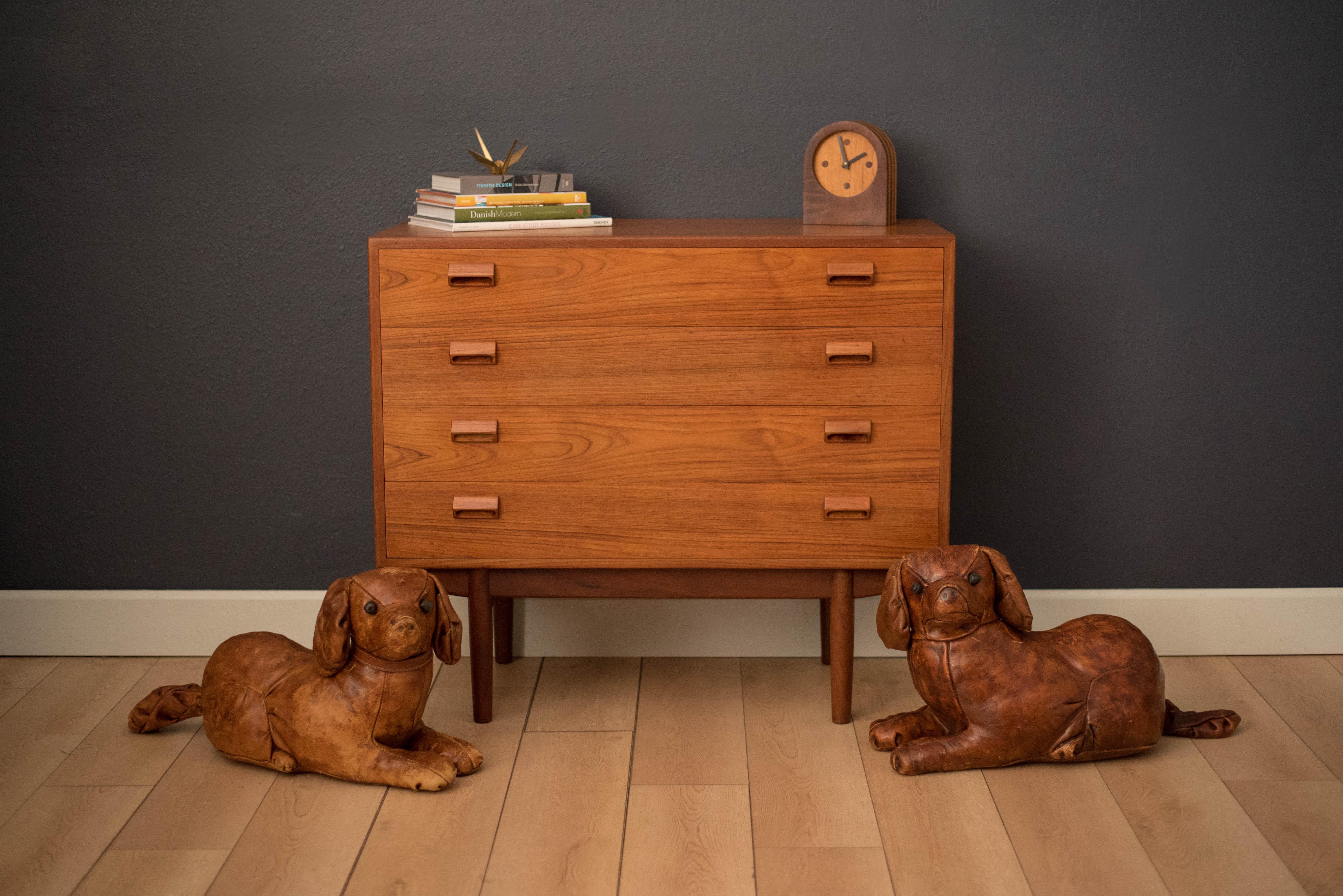 Mid-Century Modern pair of leather dogs designed by Dimitri Omersa for Abercrombie & Fitch. This decorative set is handstitched and displays a rustic aged leather patina. Price is for the pair.
