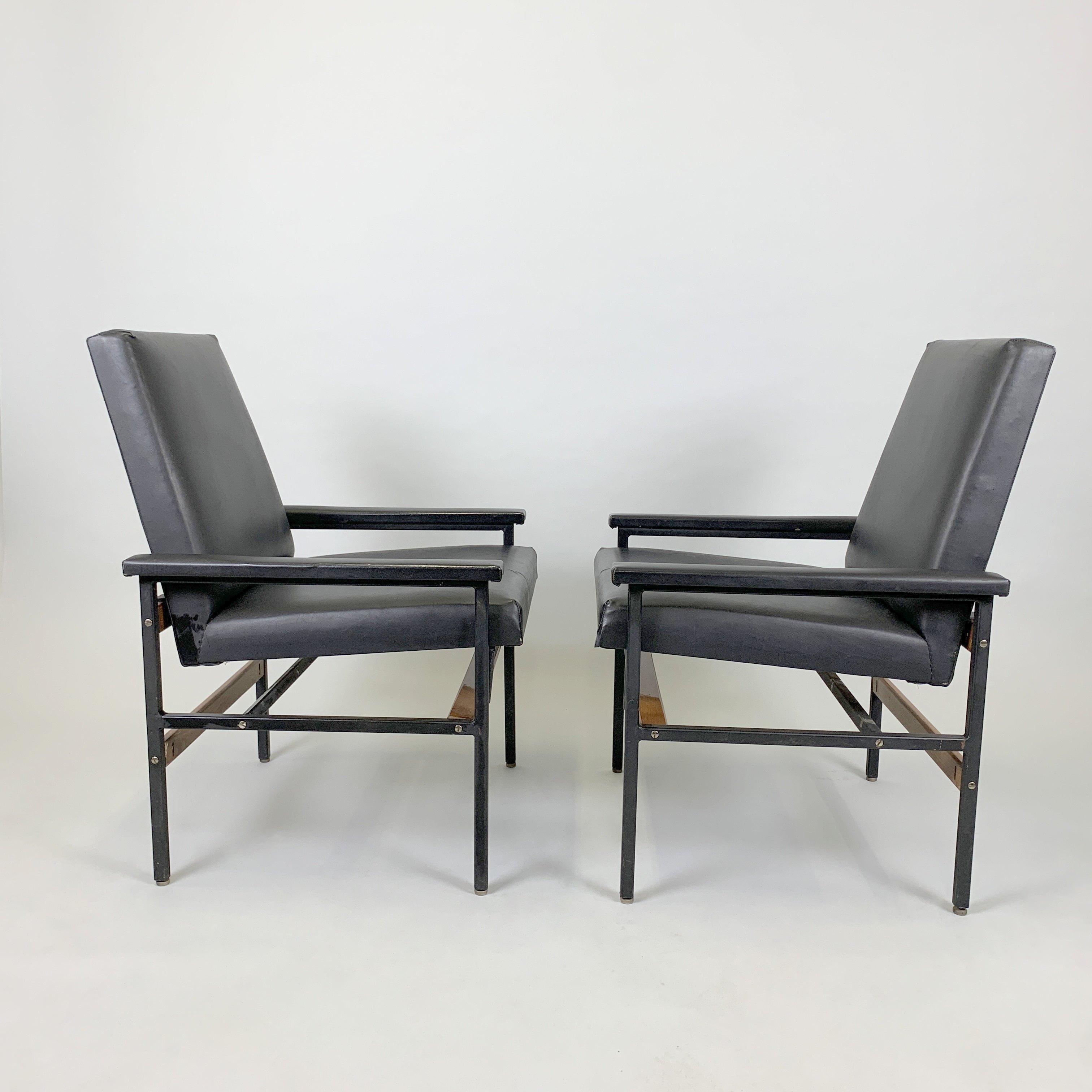 Pair of vintage adjustable armchairs made of metal, wood and leatherette. Produced in former Czechoslovakia in the 1970s. They are in a very good vintage condition except the small cracks in the upholstery (see photo).