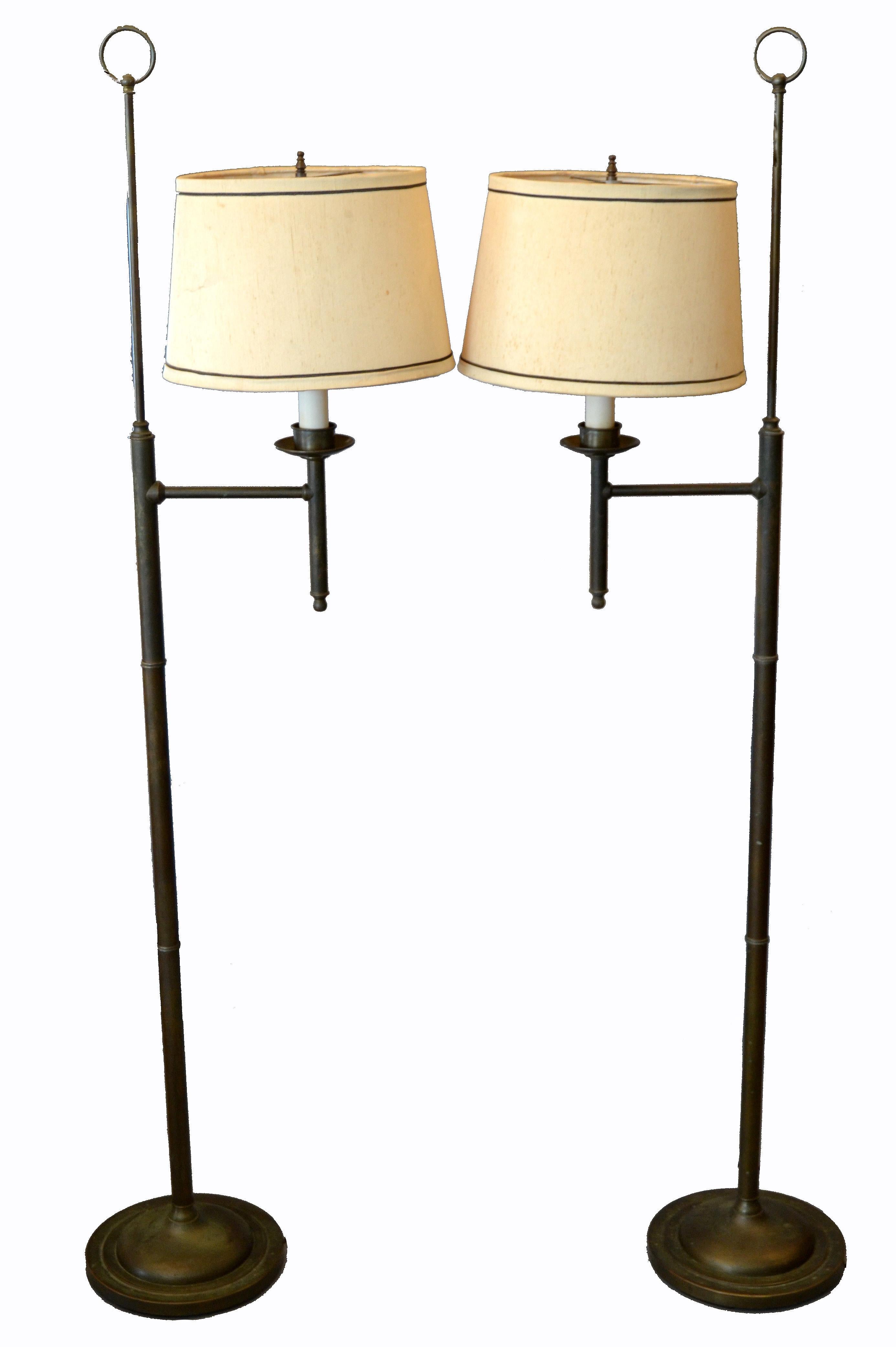 Pair of vintage American classical bronze floor lamps with shades.
They can be turned due to the swing arm.
The original Lampshades have lots of wear and we recommend to have them replaced.
Wired for the U.S. and each uses a max. 75 watts light