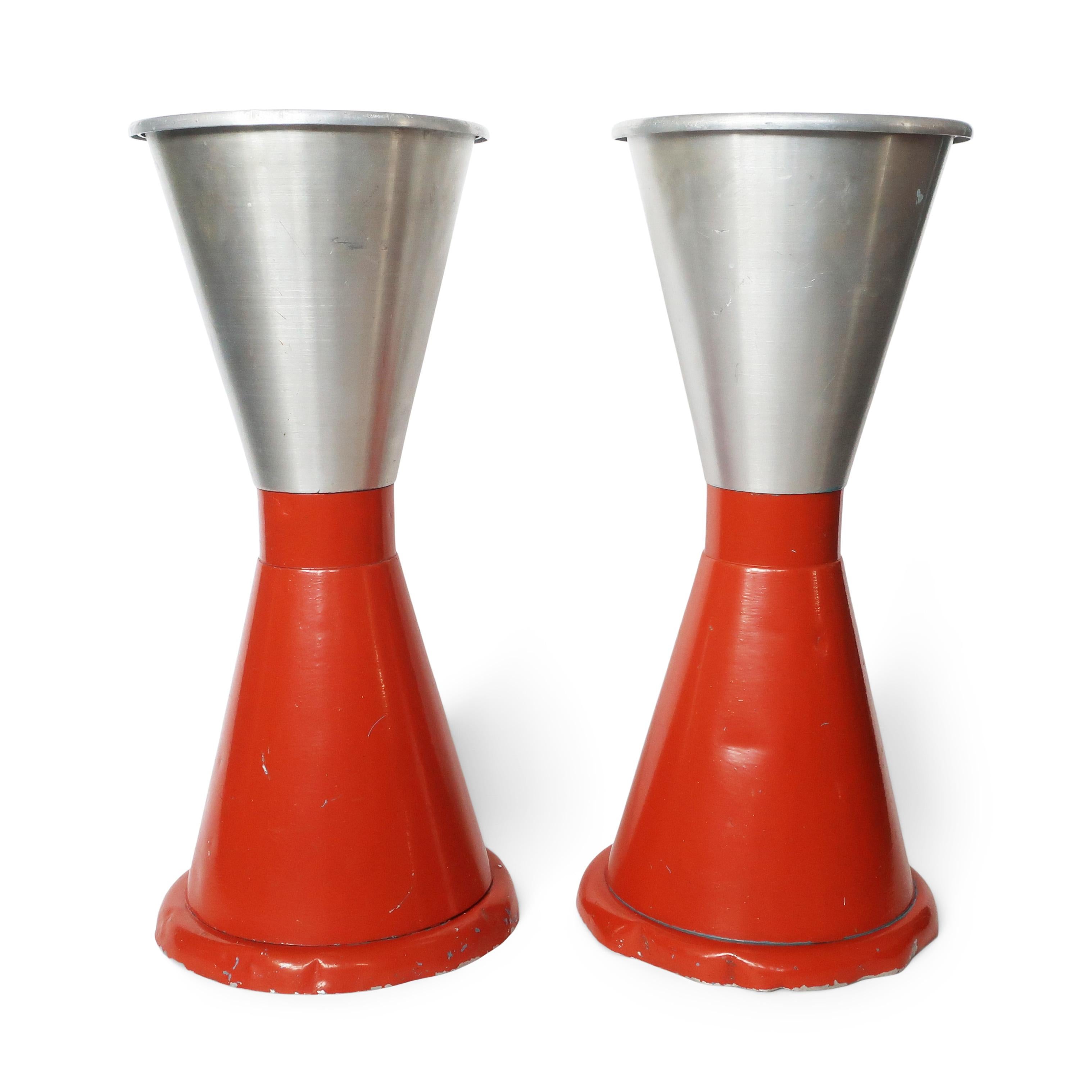 A sensational pair of Art Deco or early mid-century modern standing ashtrays.  Hourglass shaped with an orange enameled base, aluminum top, and original removable chrome trays that collect accumulated ash.   Subtle and minimalist yet full of