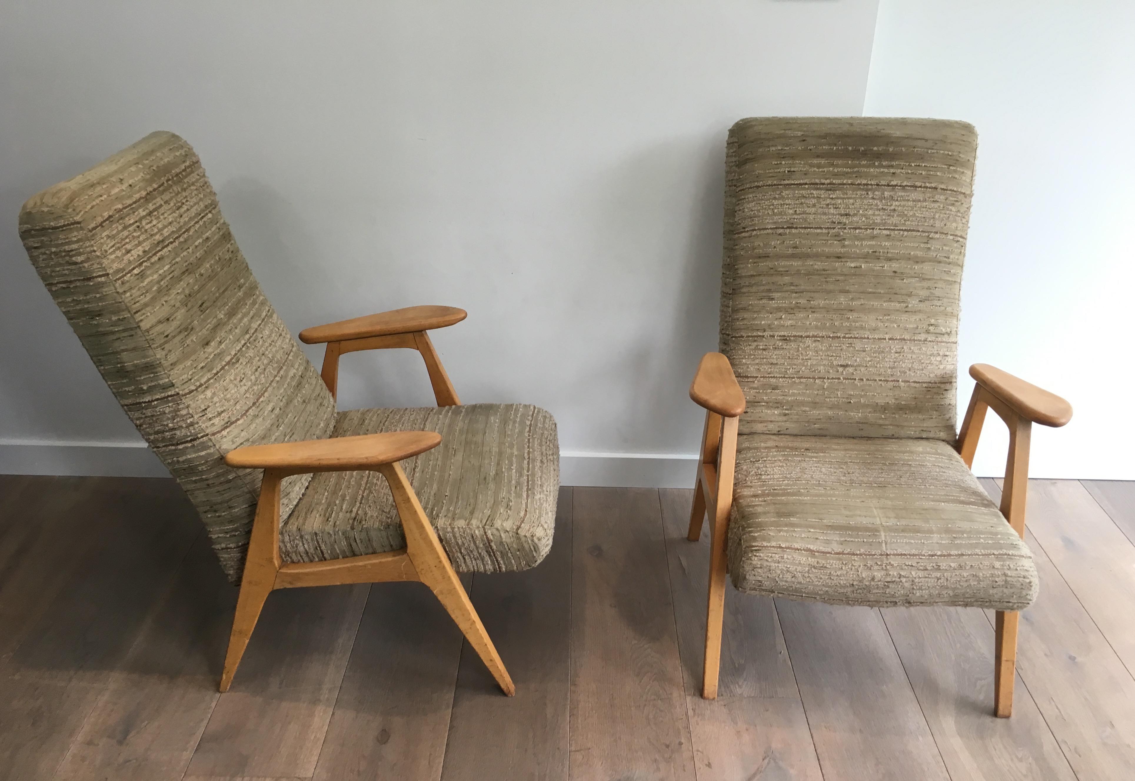 This very nice pair of vintage armchairs is made of clear wood and fabric. This is a French work, circa 1970.