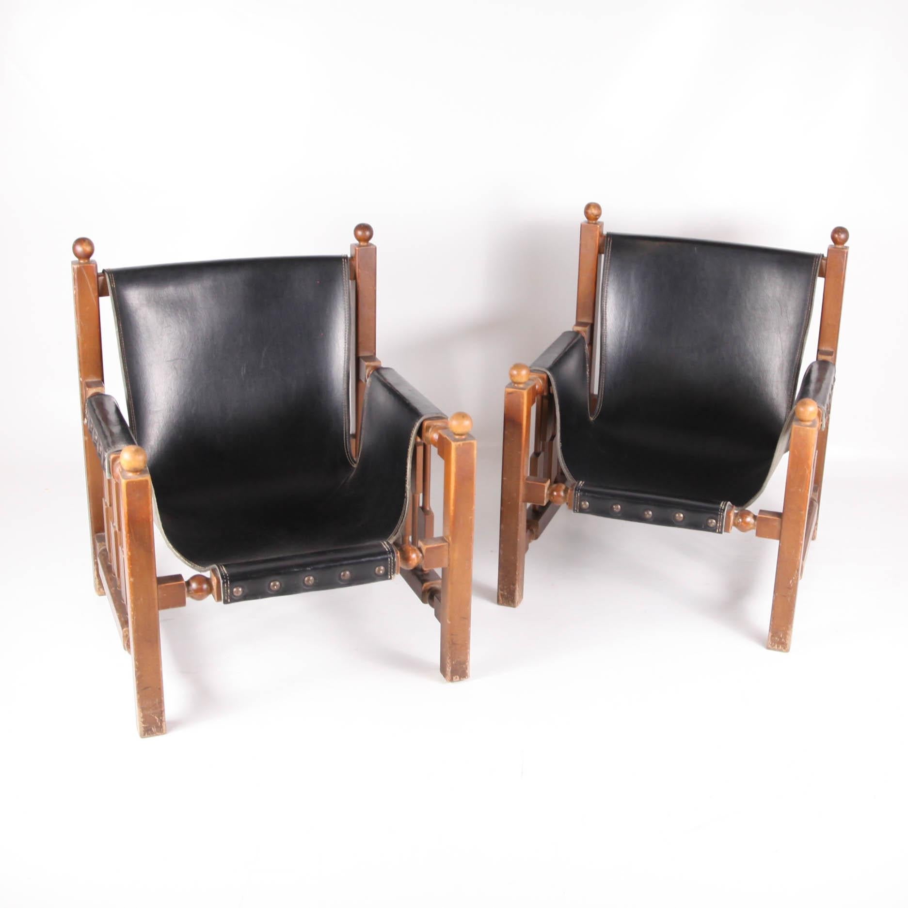 Pair of vintage armchairs in faux leather and wood.