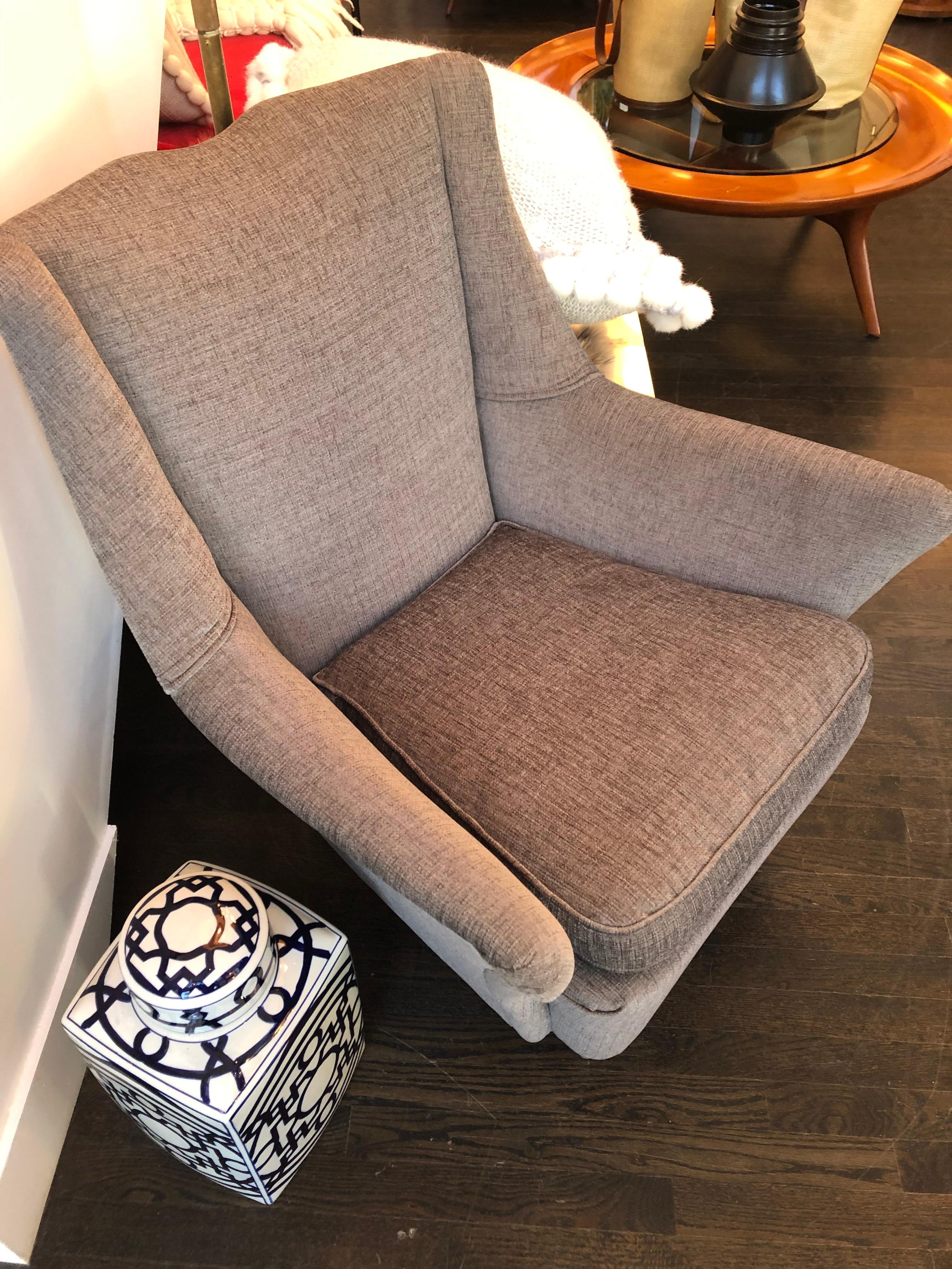 These handsome upholstered vintage Italian chairs have tight backs and loose seat cushions and are newly re-covered in a textured grey linen fabric.  The splayed arm details, notched detail on center of chair backs and the straight wooden front legs