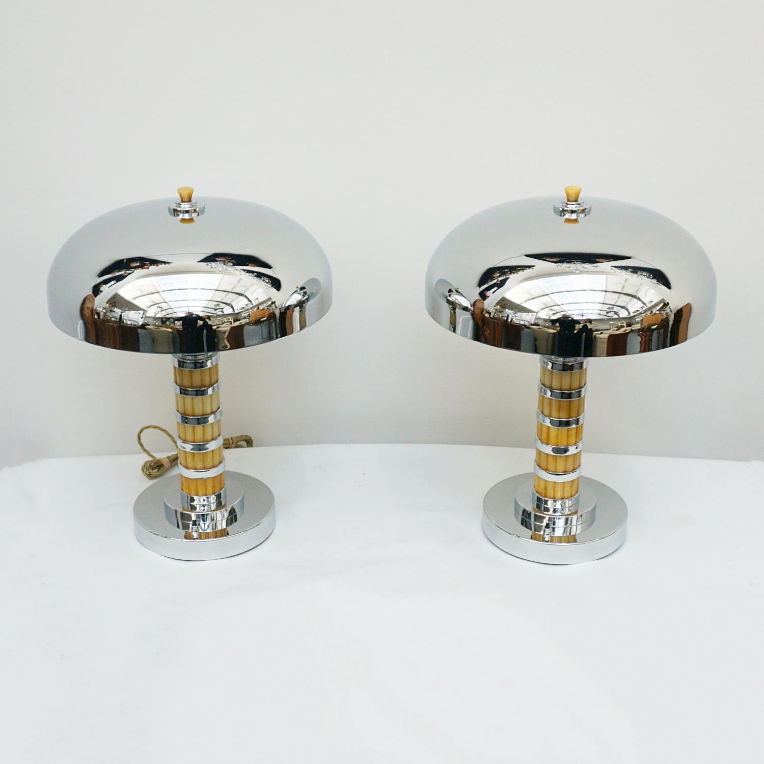 A pair of Bakelite and Chrome Dome Lamps. Rippled yellow bakelite with chromed banded stem over a chromed metal base and domed chrome shade. Yellow bakelite finial to top. 

Dimensions: H 48cm Diameter of Shade: 37cm, of base: 20cm

Item Number: