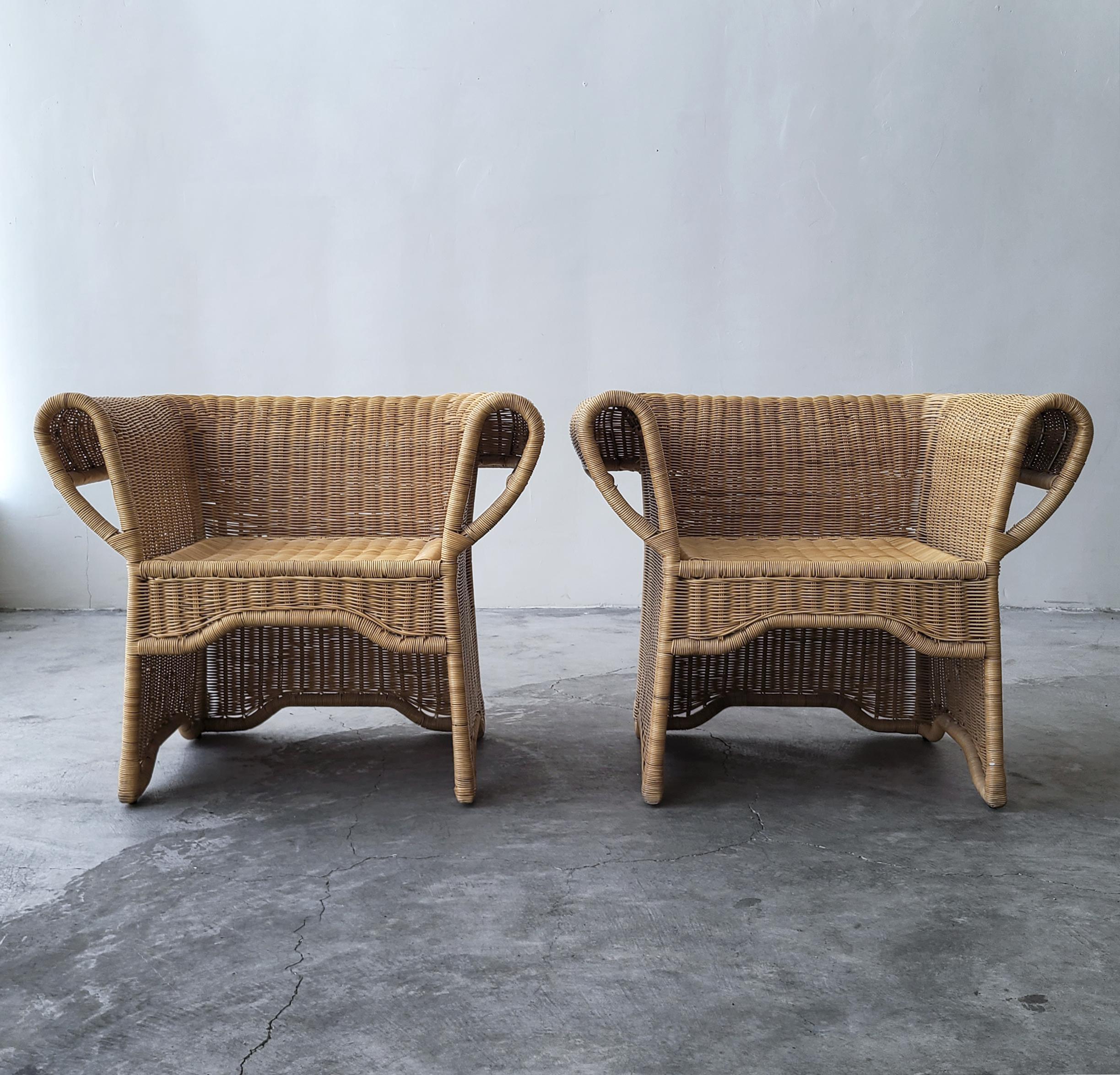 Gorgeous pair of Arurog wicker chairs. This pair has the most beautiful details with its looped arms. Metal framed wicker furniture is a rarity, and built to last. The set is in incredible condition with next to no signs of use. 

Listing is for 2