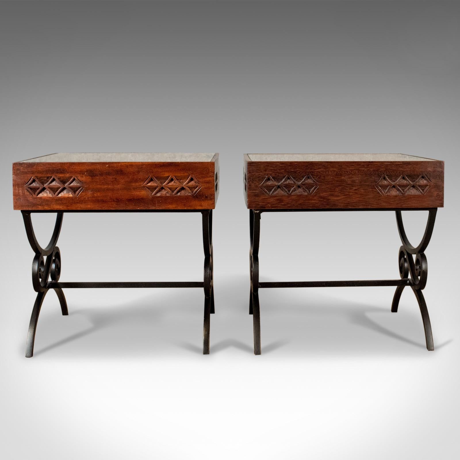 This is a pair of vintage Asian side tables, heavy, carved teak, coffee tables with glass tops raised on wrought iron legs dating to the late 20th century.

Attractive carved geometric panels with iron fixings
Inset to a deep frame decorated with