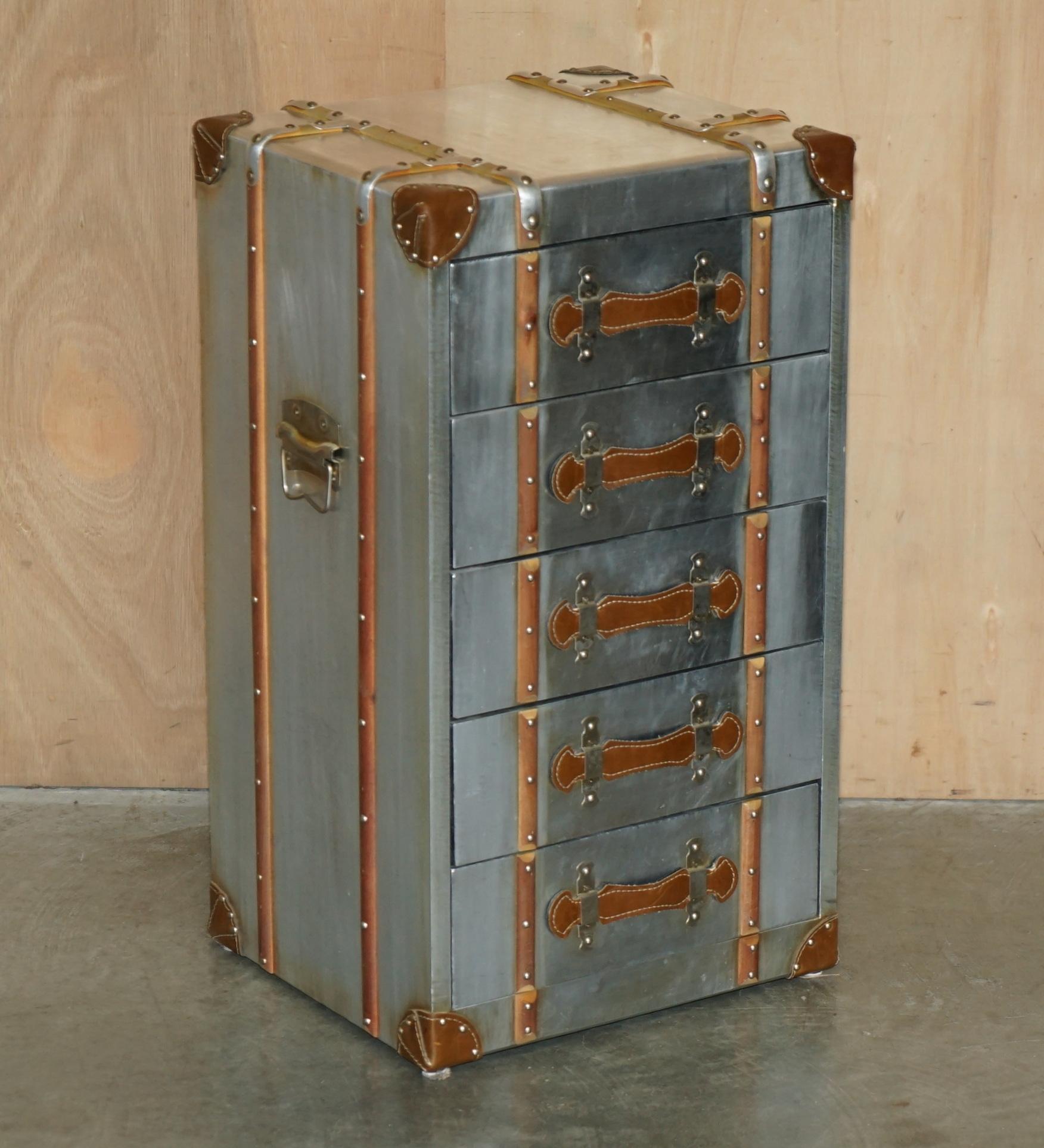 Royal House Antiques is delighted to offer for sale this stunning pair of vintage Aviator style tall nightstand bedside tables in polished Aluminum with hand hammered studs

Please note the delivery fee listed is just a guide, it covers within the