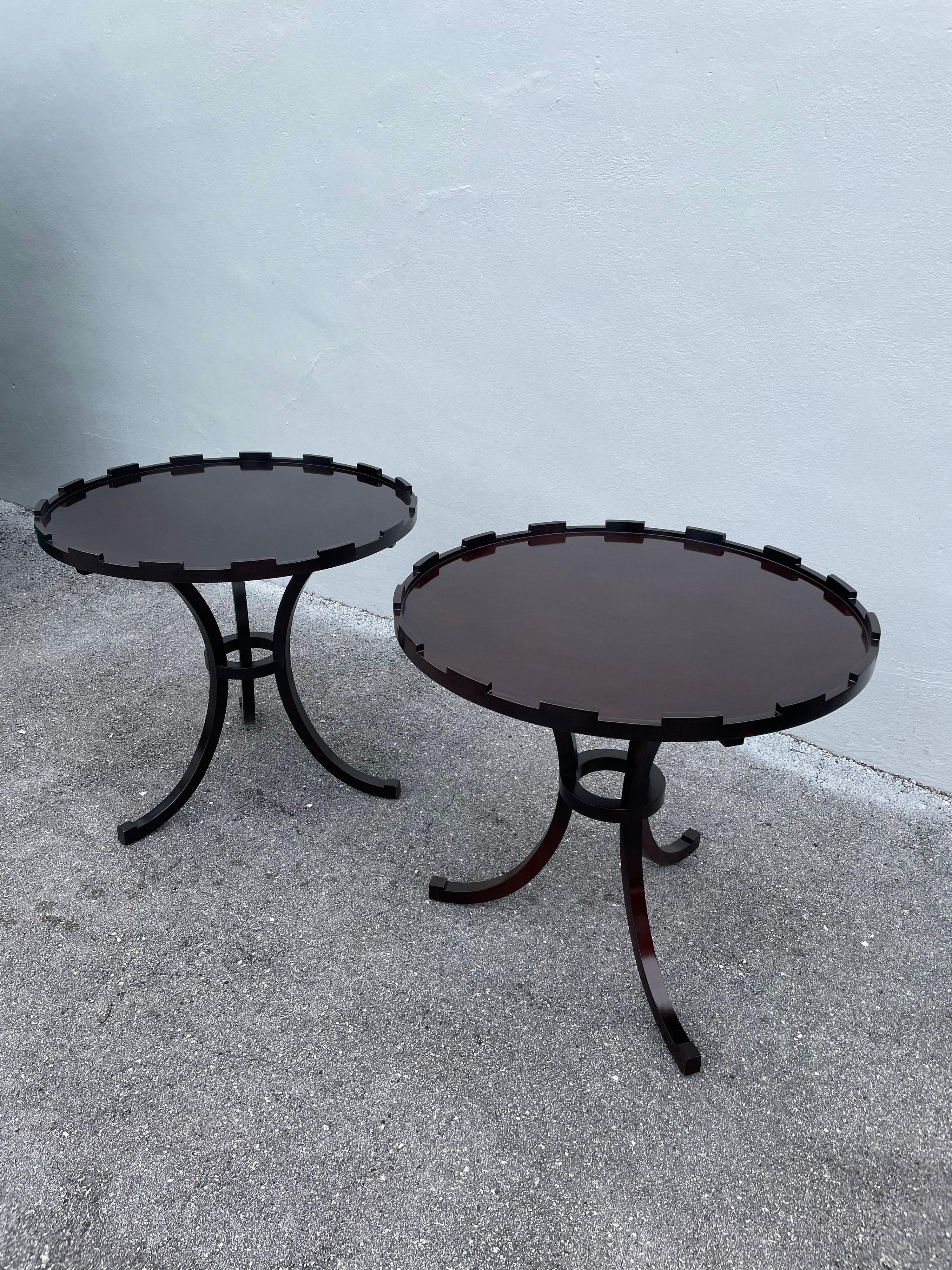 This vintage pair of burnt tone mahogany round gueridons by Baker Furniture. Crown detail trim to top and 3 splayed legs with ring accent. Both retain original Baker metal tags. Great for side tables, night tables, etc.